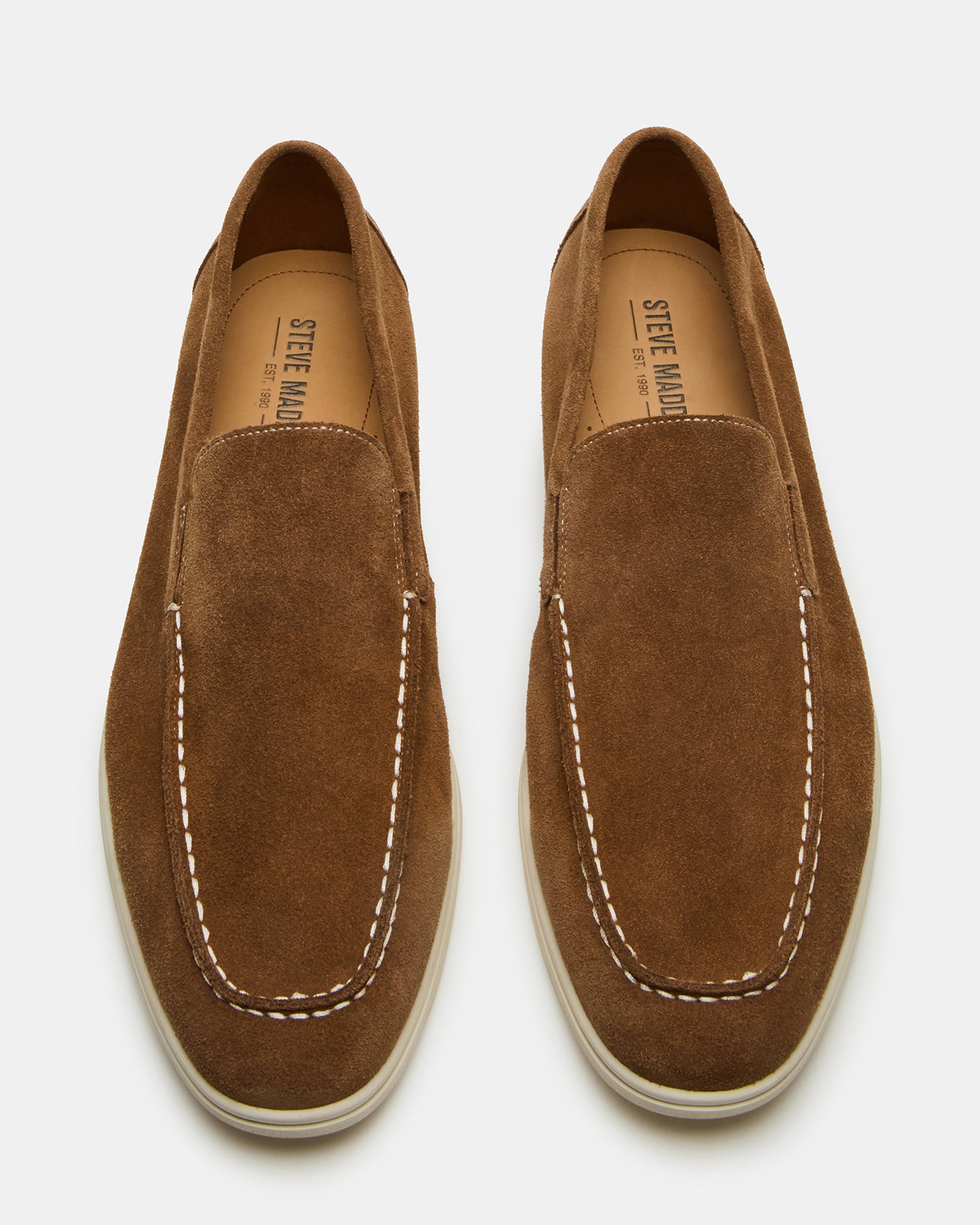 Close-up of LINUX brown suede slip-on shoes showcasing the soft material.