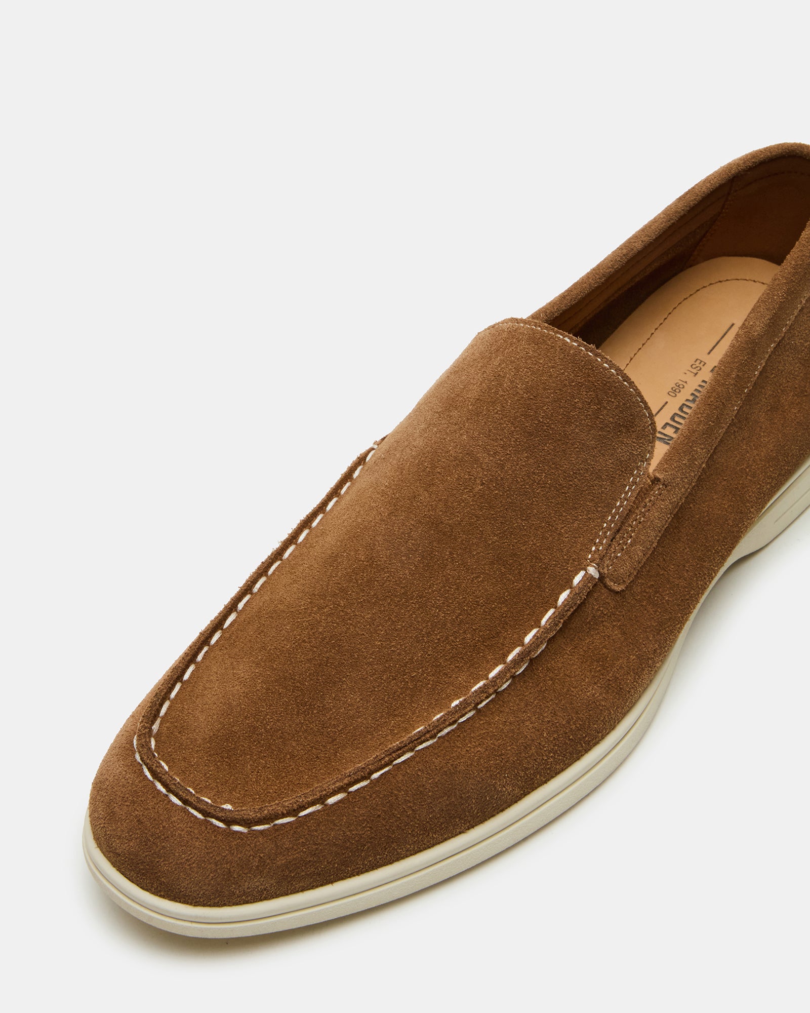 Side view of LINUX brown suede slip-on shoes highlighting the slip-on design.