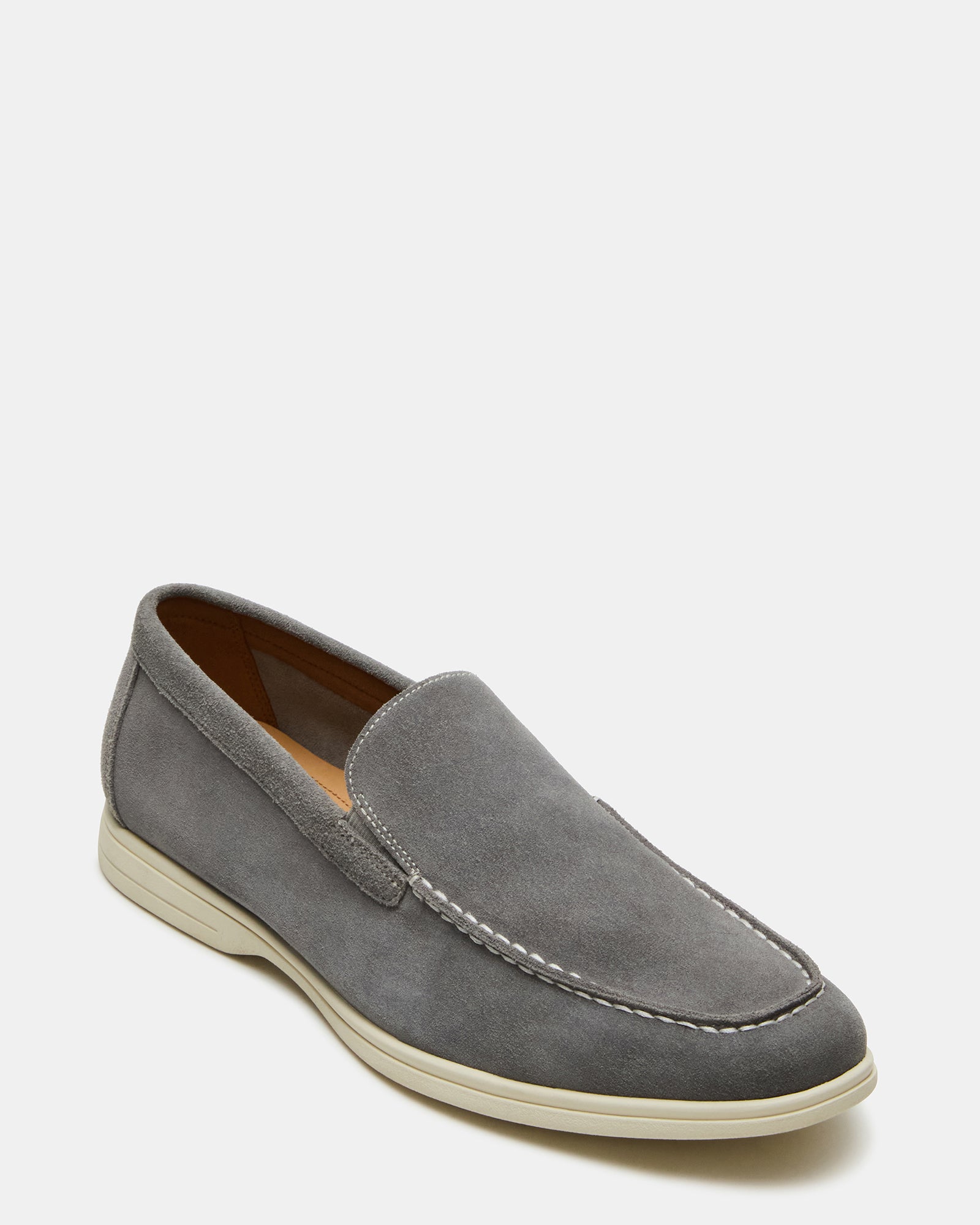 Close-up of textured suede material and stitching on mens slip-on shoes