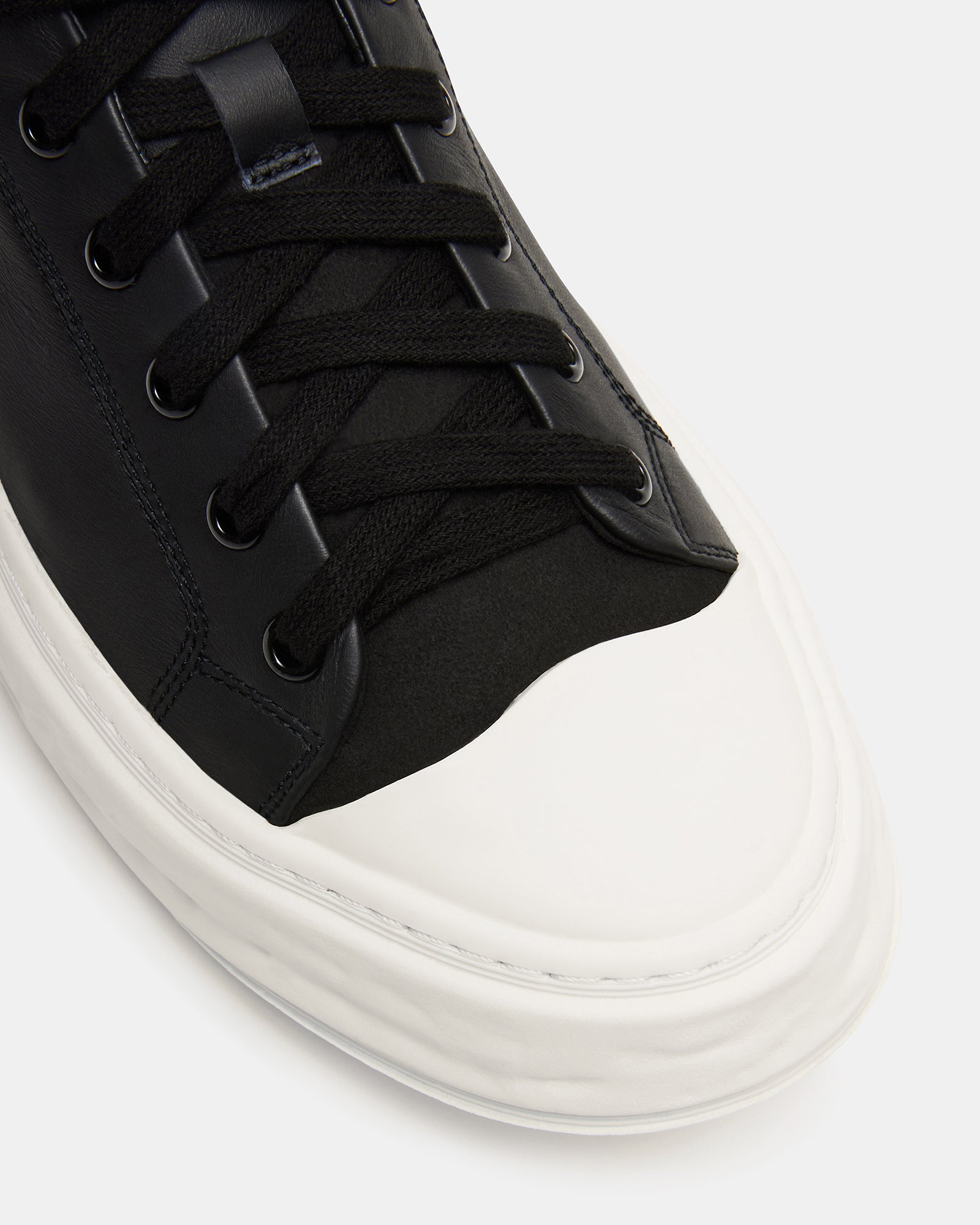 Fashionable all black sneakers on a city street, ideal for everyday style