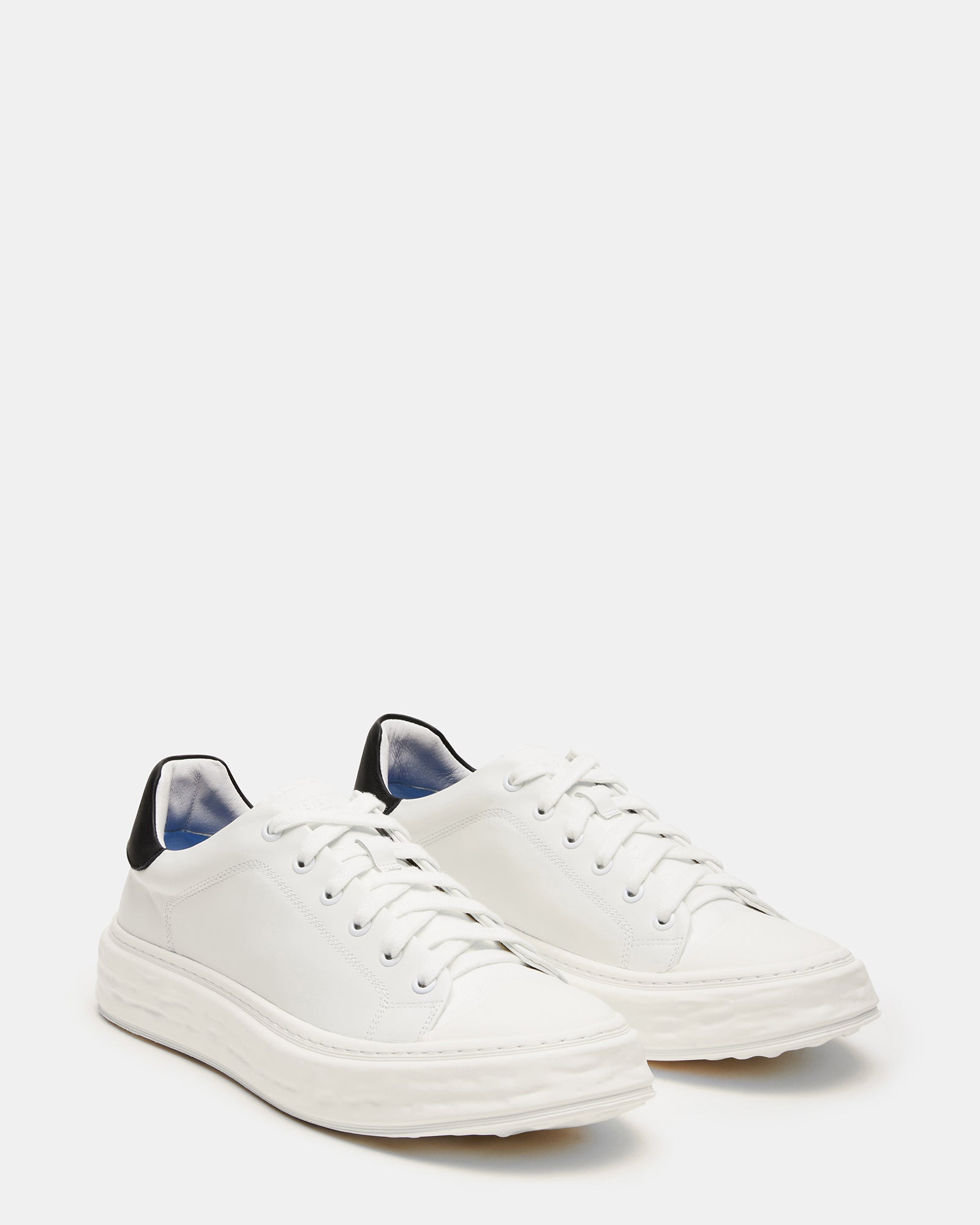 Top view of low-top mens leather sneakers featuring a classic cap toe.