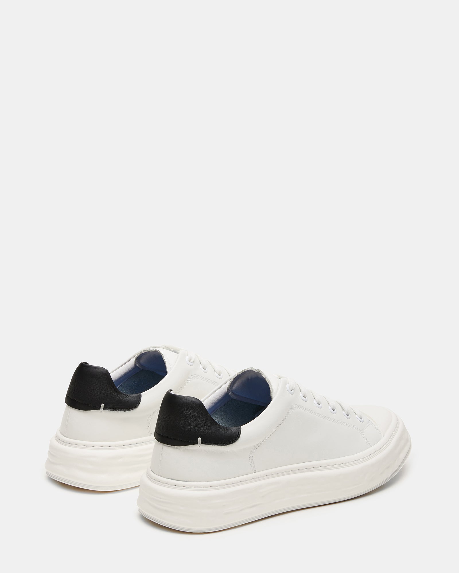 Top view of low-top mens leather sneakers featuring a classic cap toe.