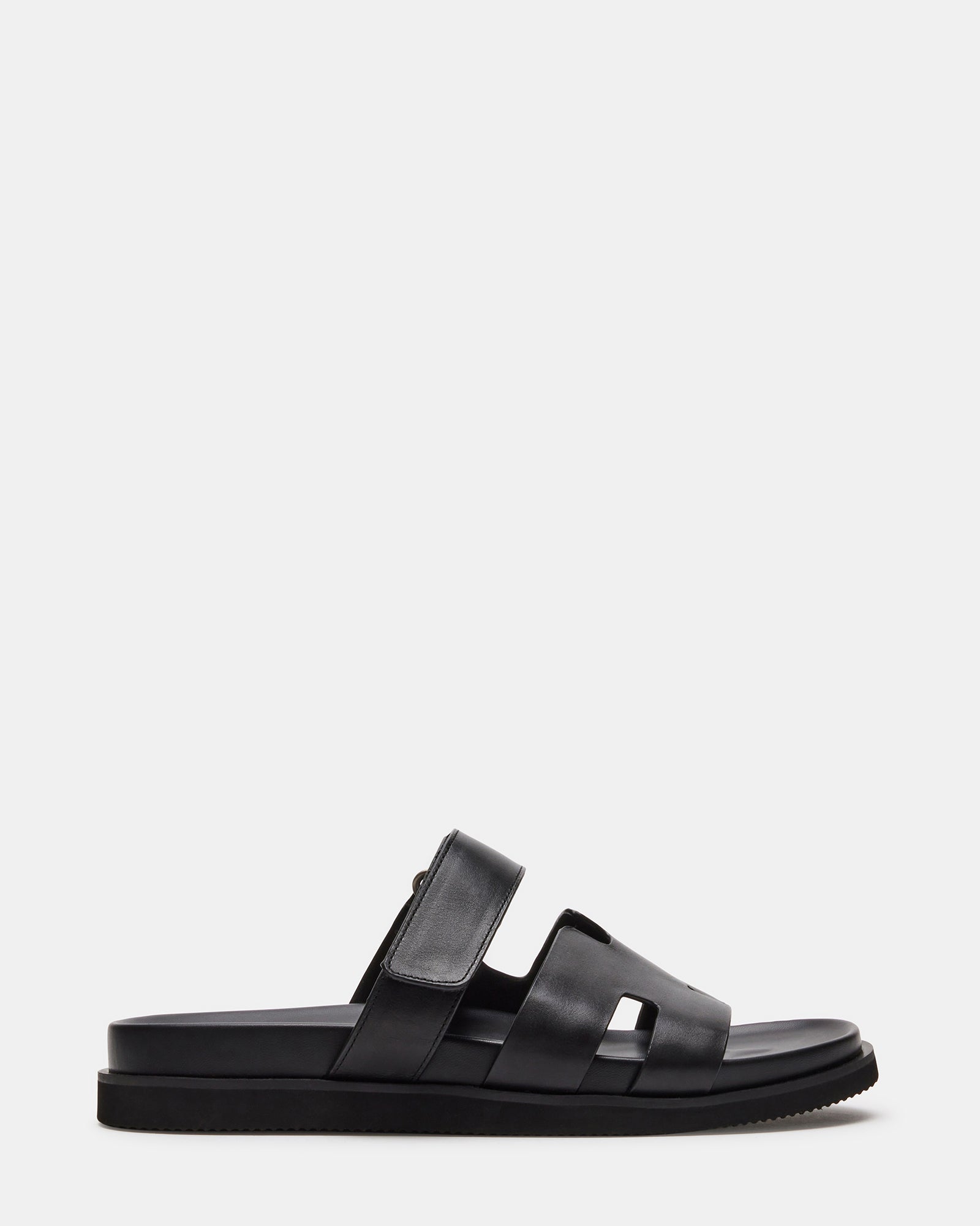 Close-up of black leather sandals with slip-on design and 1.5-inch heel, ideal for summer wear