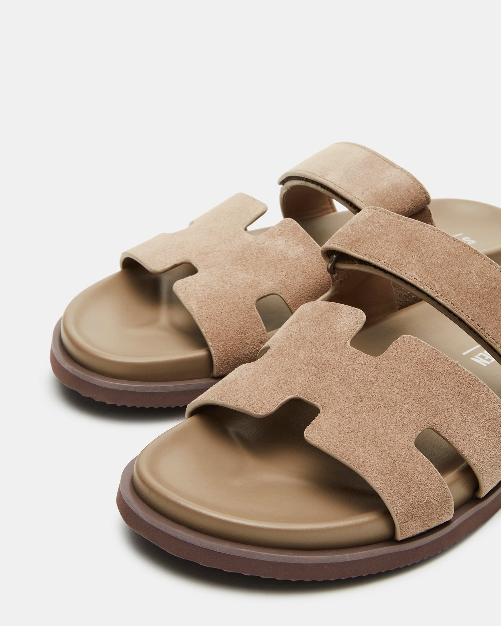 Close-up of taupe suede sandals showcasing the soft material and stylish design.
