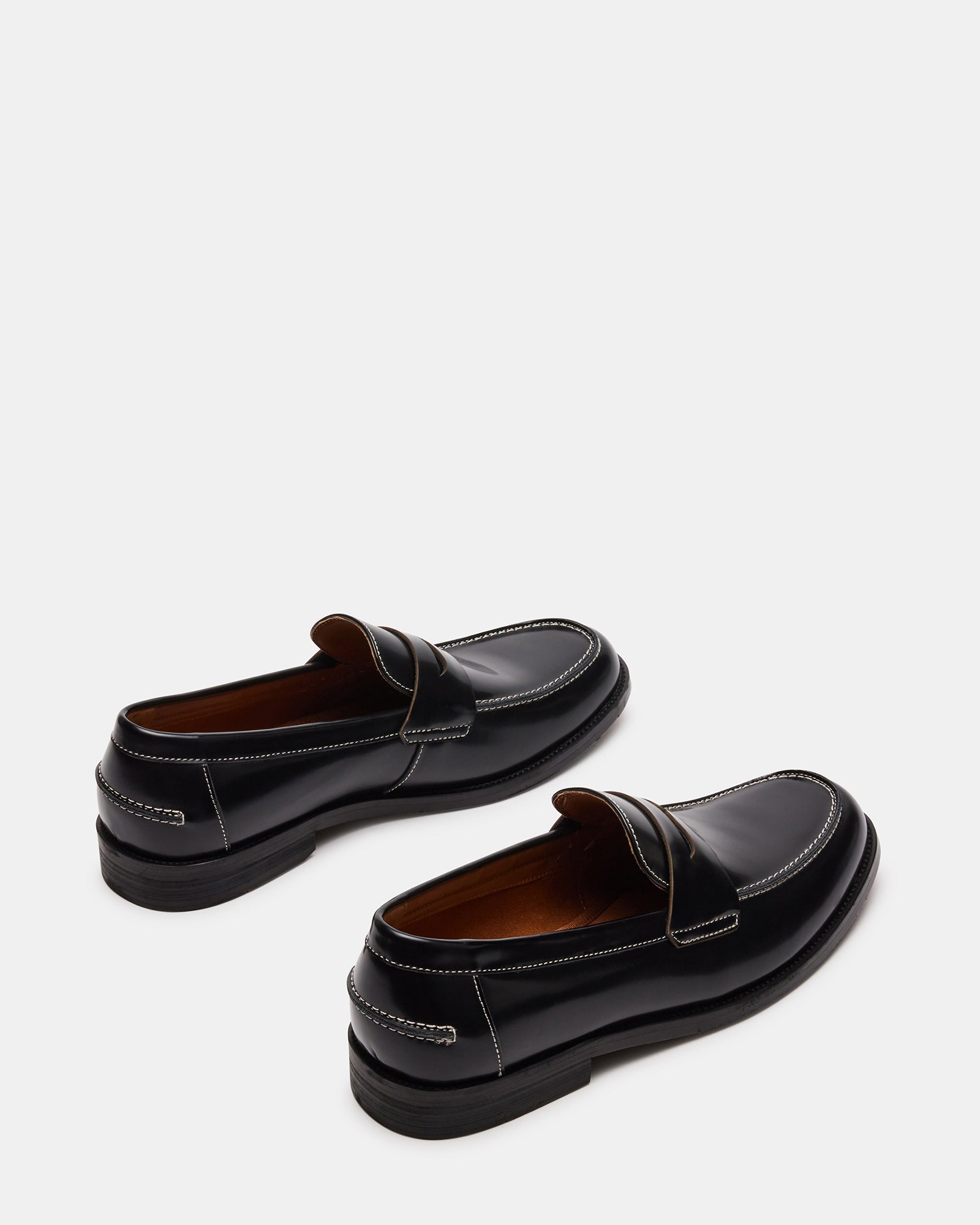 Close-up of Natan black leather loafers, emphasizing the craftsmanship.