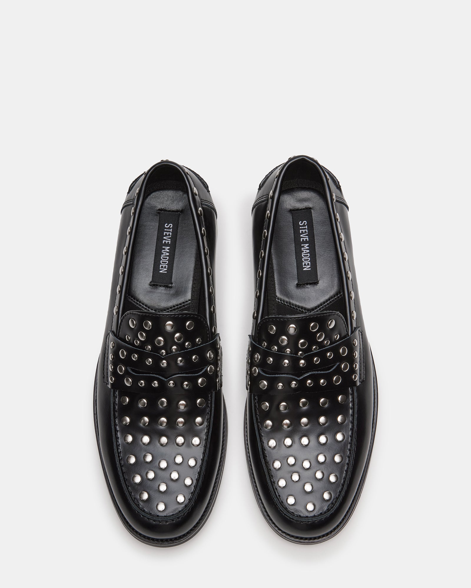 Mens black leather loafers paired with slim-fit trousers