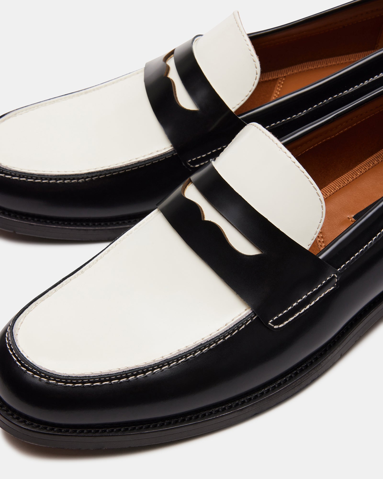 NATAN leather loafers in black-and-white, angled to show textured sole
