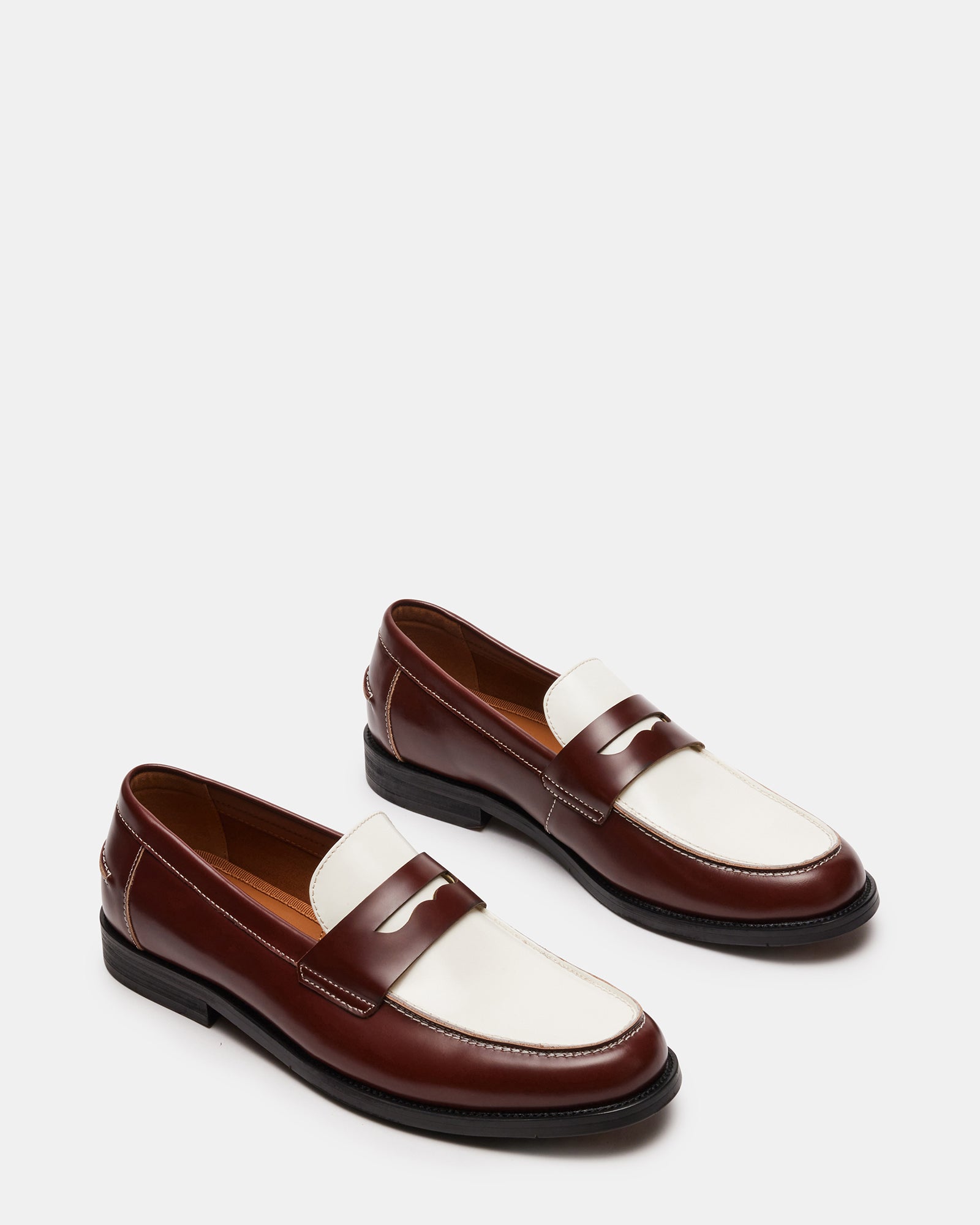 Side view of NATAN Brown Multi loafers on display in an elegant setting.