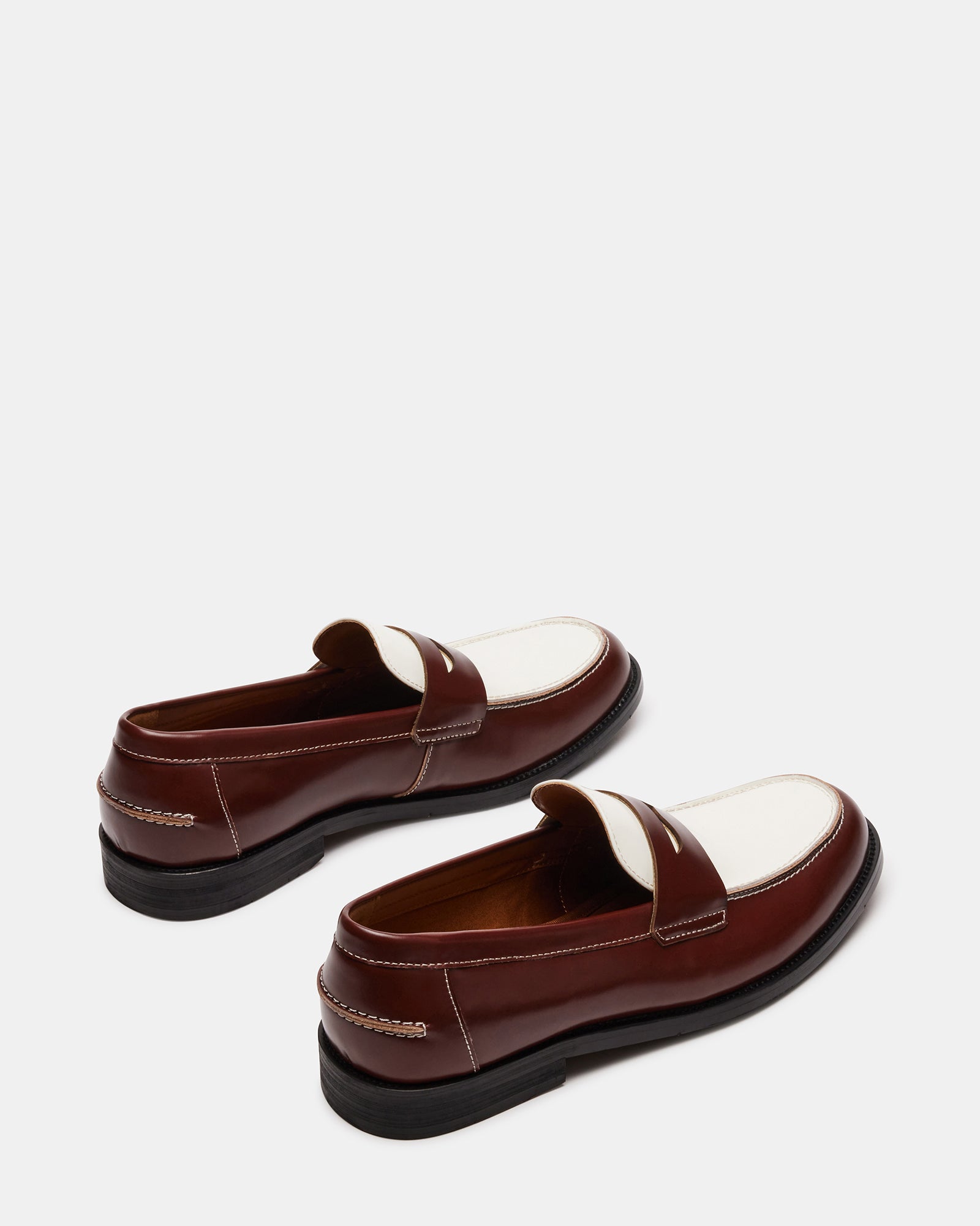 Side view of NATAN Brown Multi loafers on display in an elegant setting.