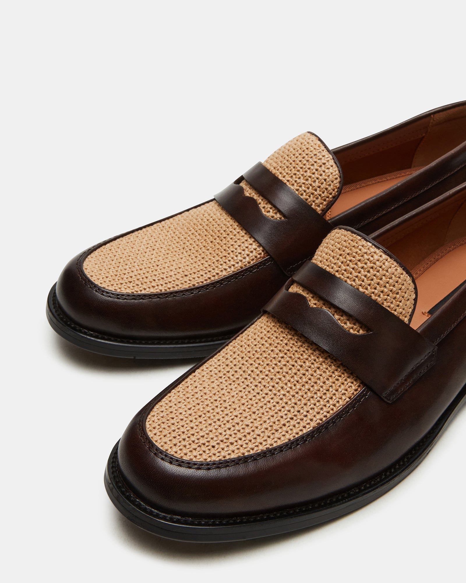 Angled view of leather mens loafers showcasing dress shoe stitching and dual-tone finish