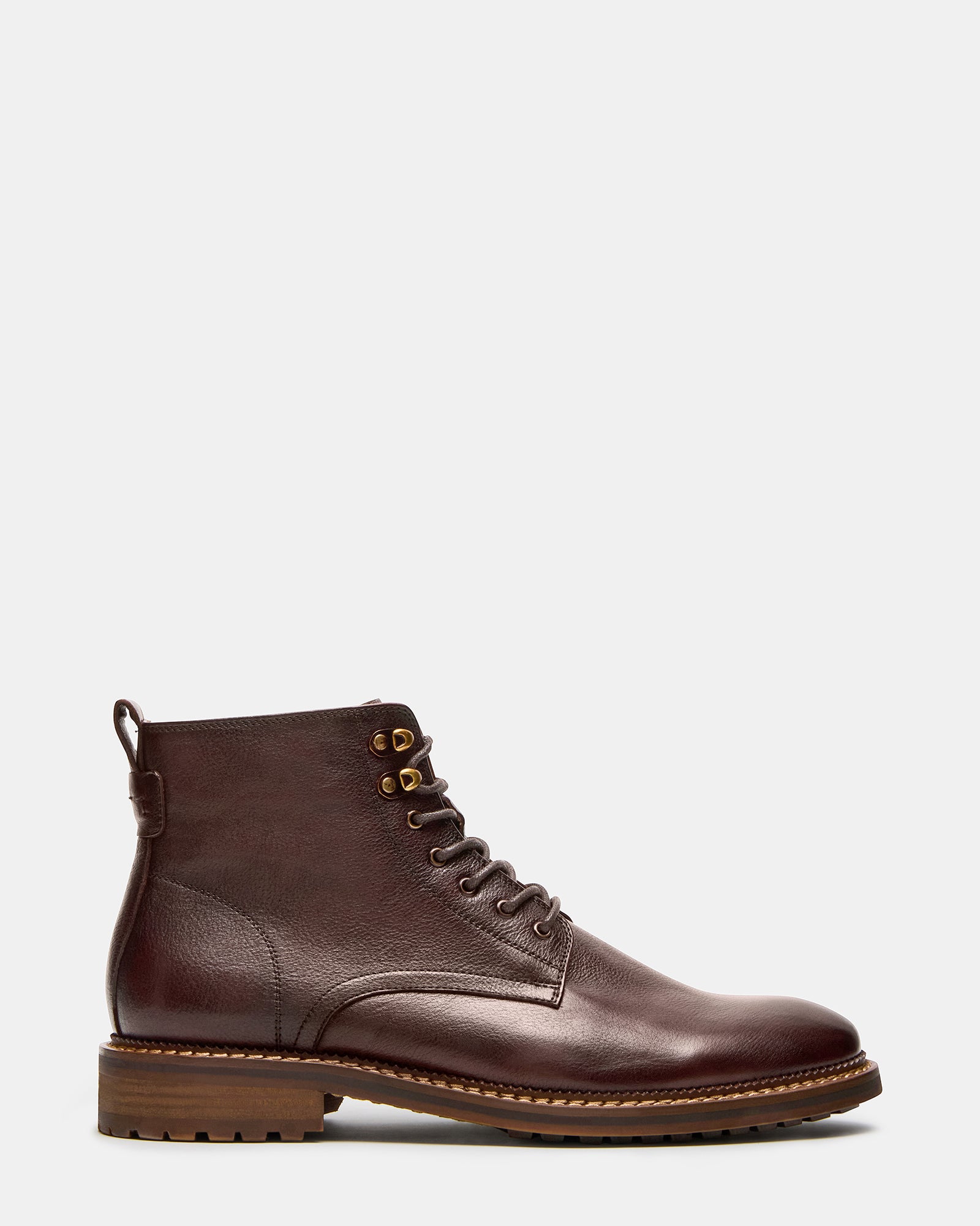 Brown lace up boots photographed outdoors on a stone path — ideal for fall outfits