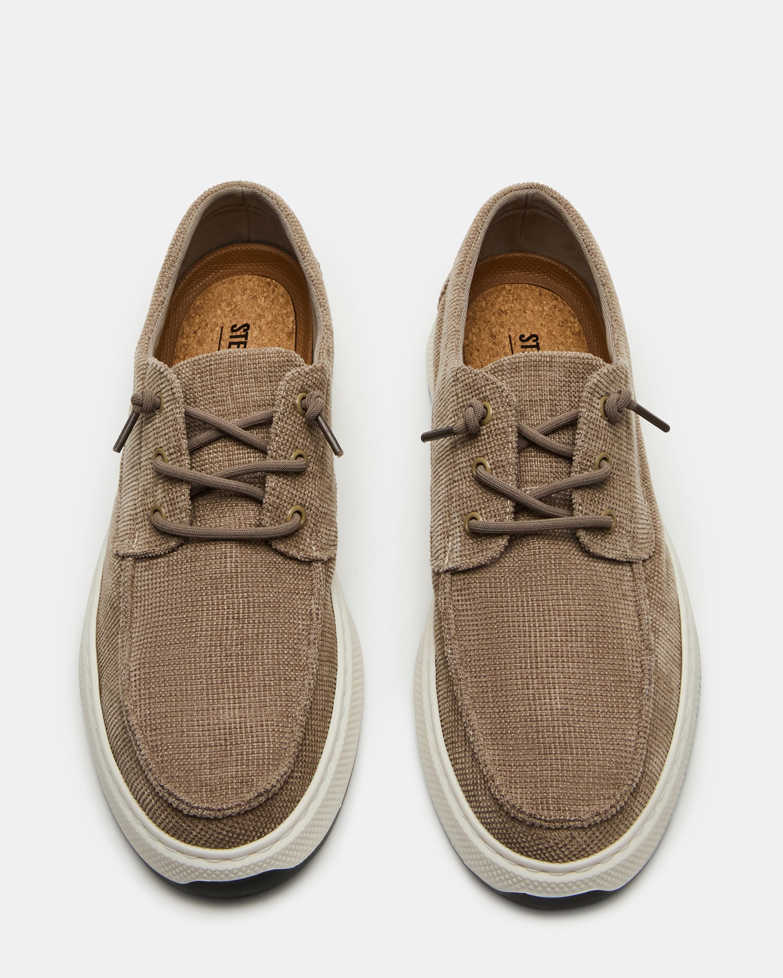 Close-up of NUSCHI taupe slip-on shoes highlighting the rounded toe and textile upper