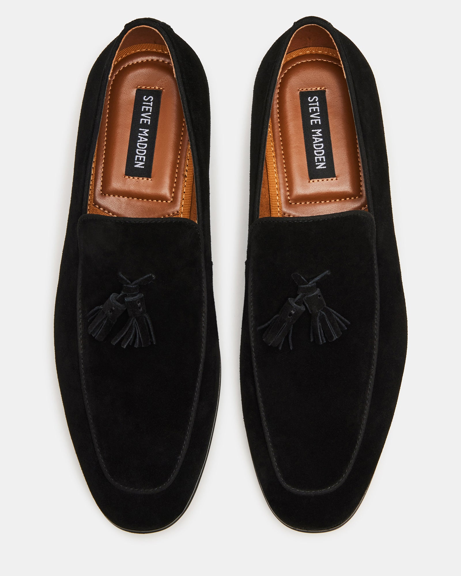 Side view of ONDRE black suede tassel loafers showcasing the almond toe and tassel detail