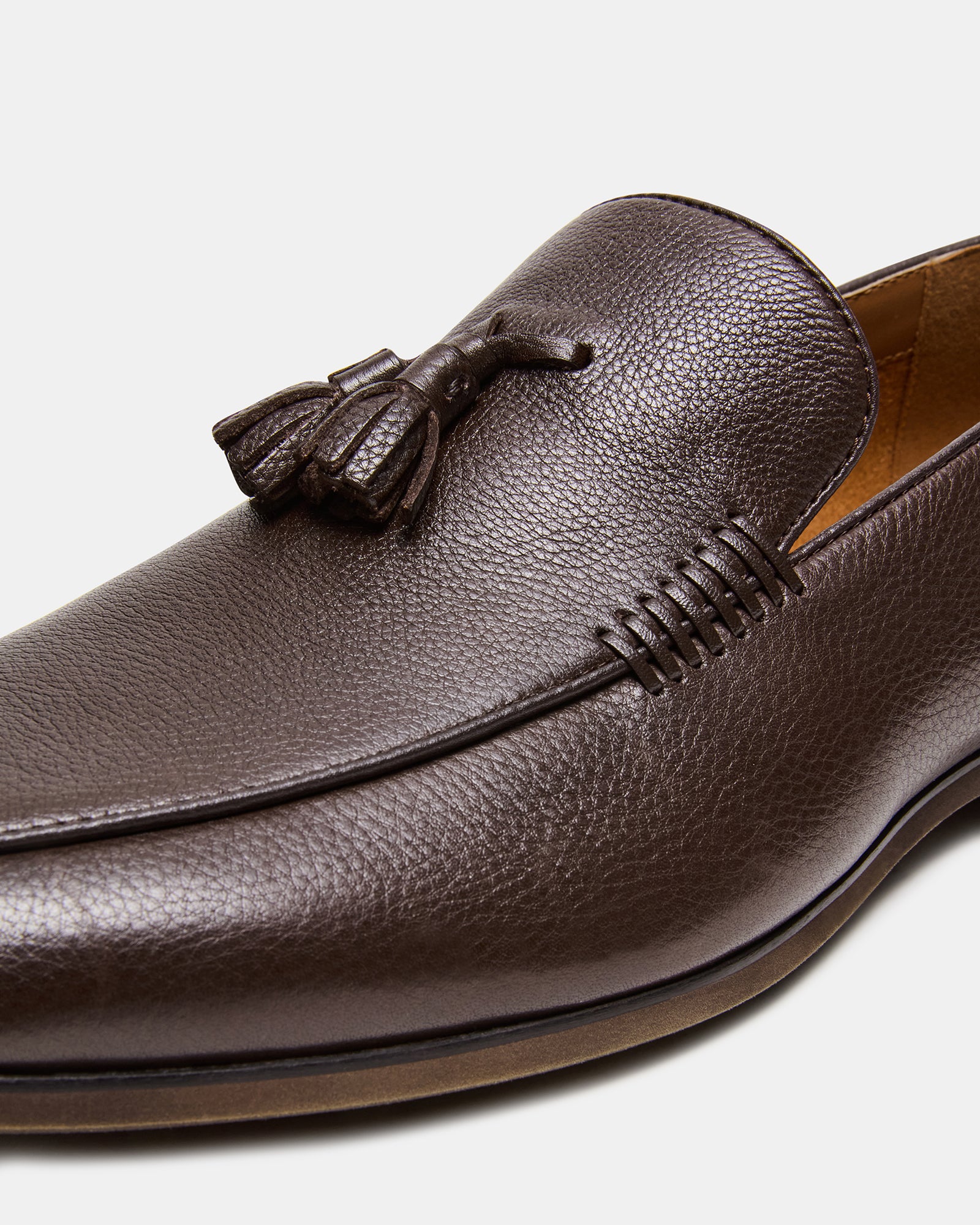 Close-up of ONDRE luxury leather loafers showcasing the tassel detail.