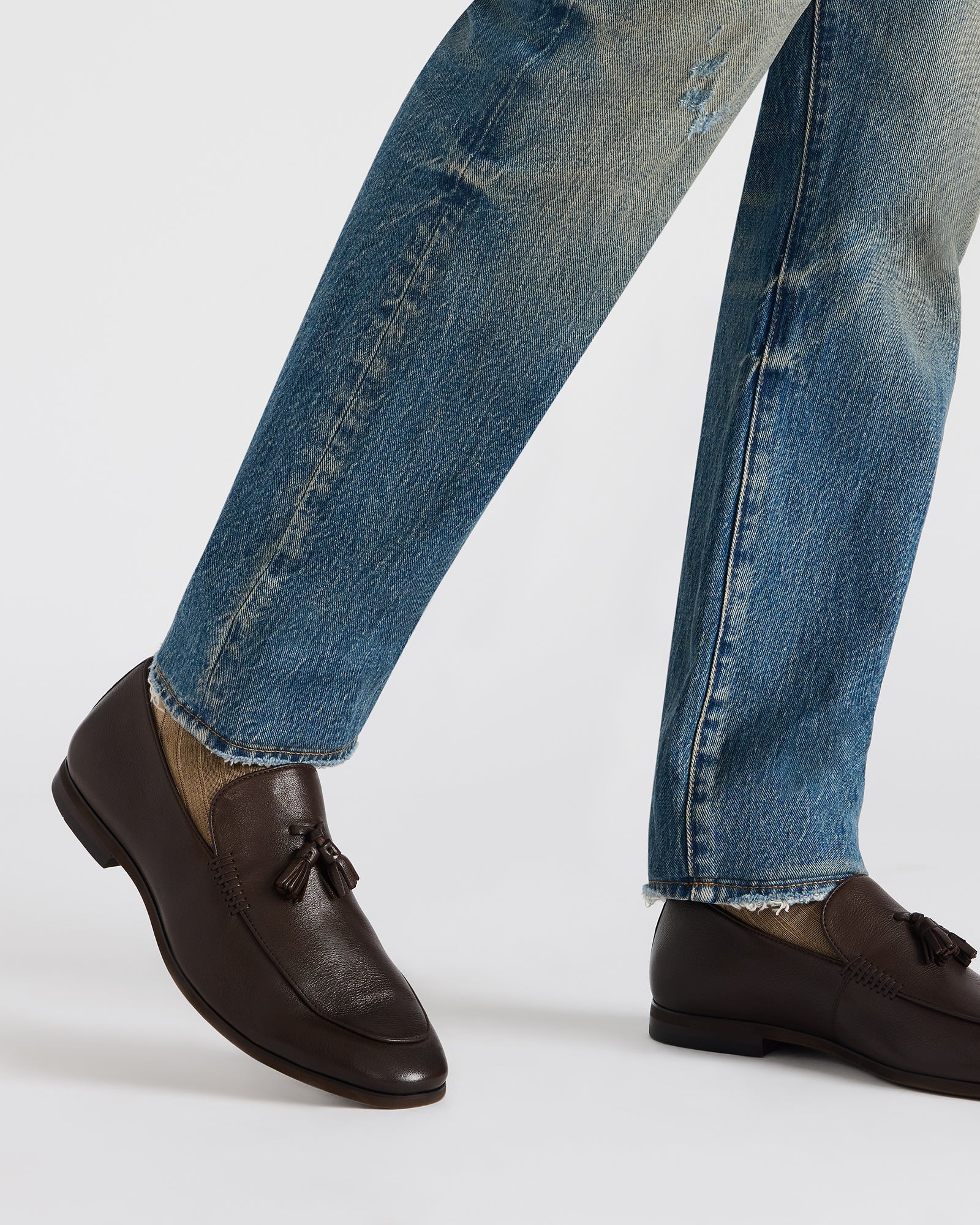 Stylish ONDRE brown leather loafers paired with business casual attire.