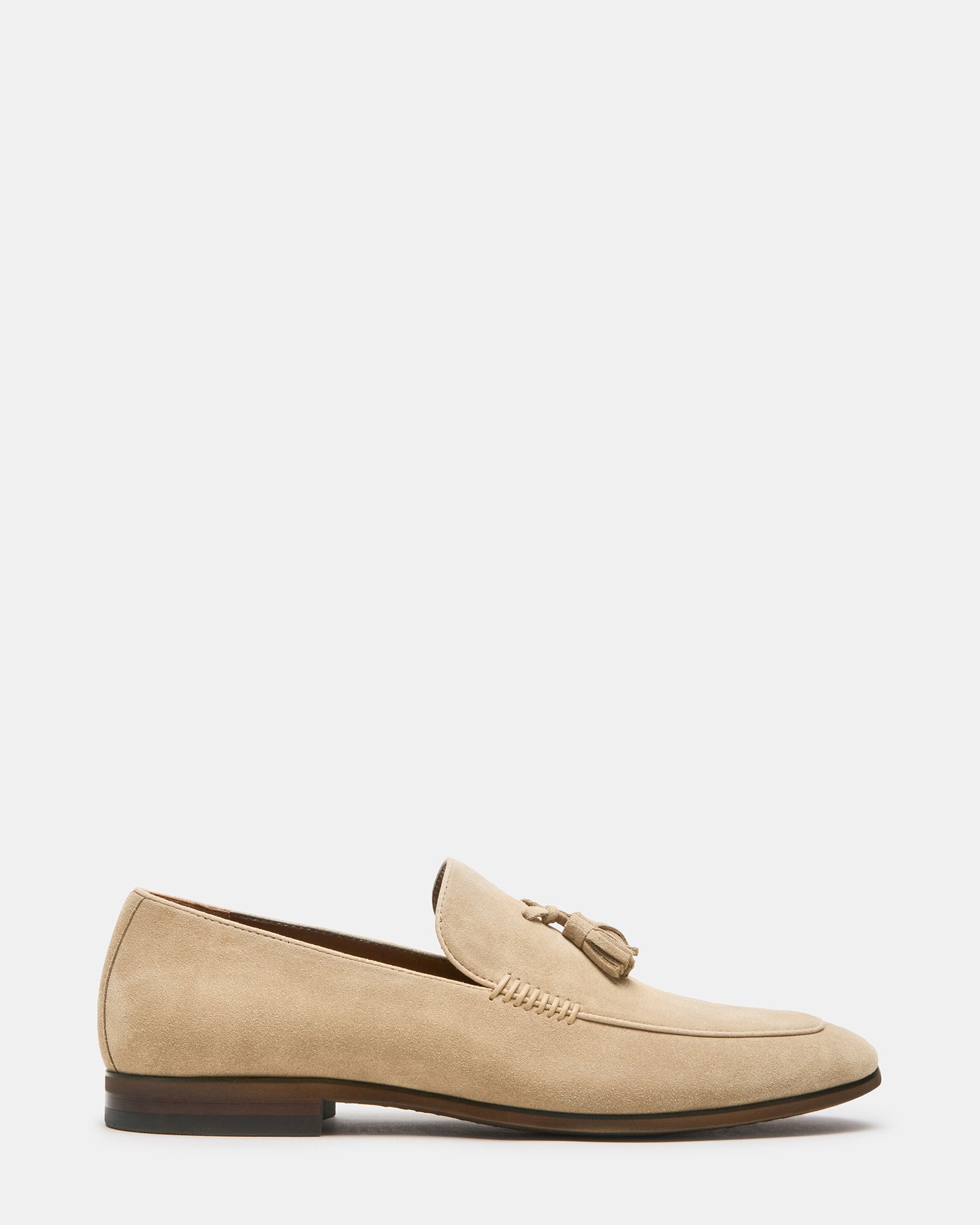 Close-up of men's sand suede loafers showing tassel and almond toe design
