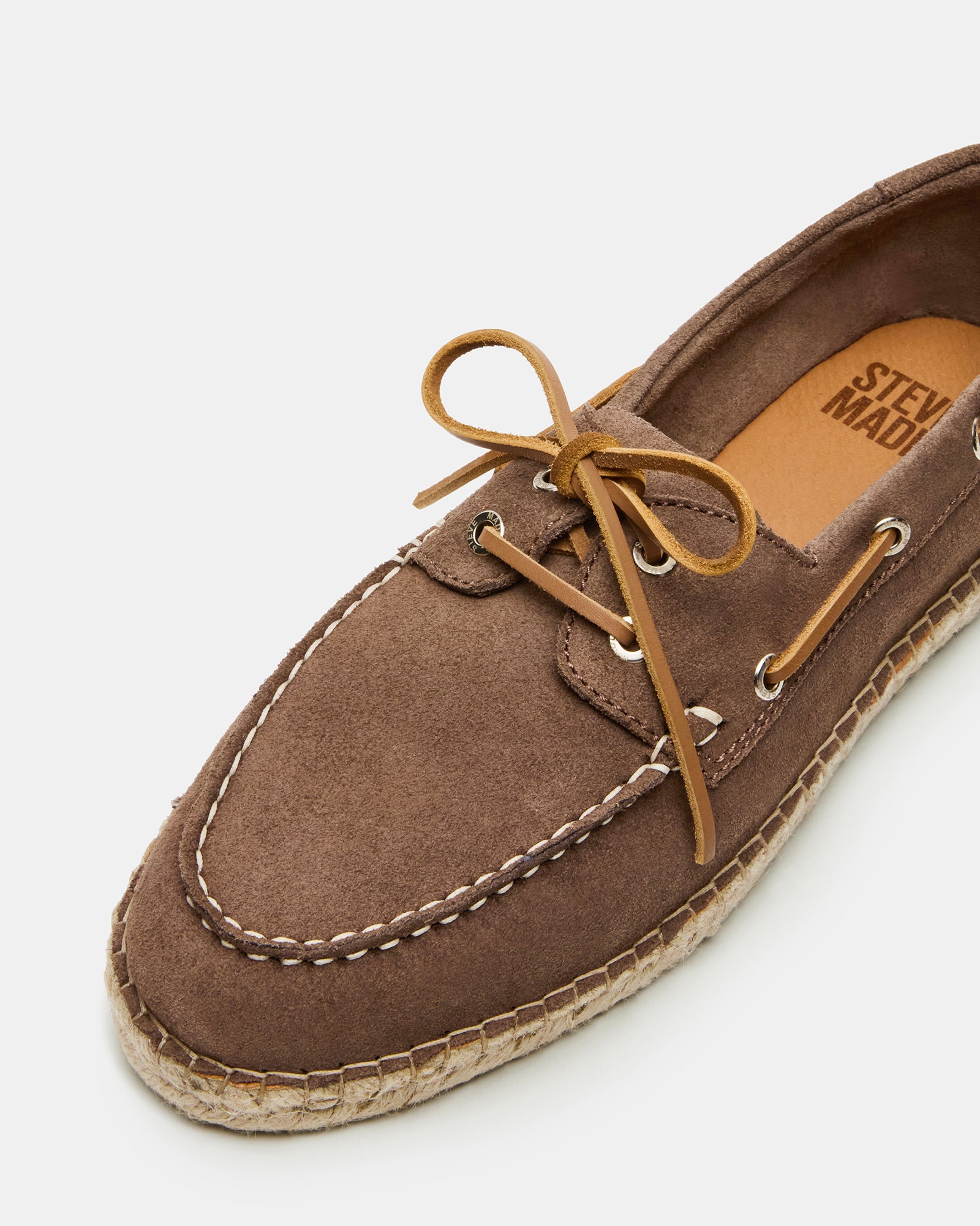 Side view of Pancho taupe suede slip-ons on a wooden deck, ideal for summer outings.