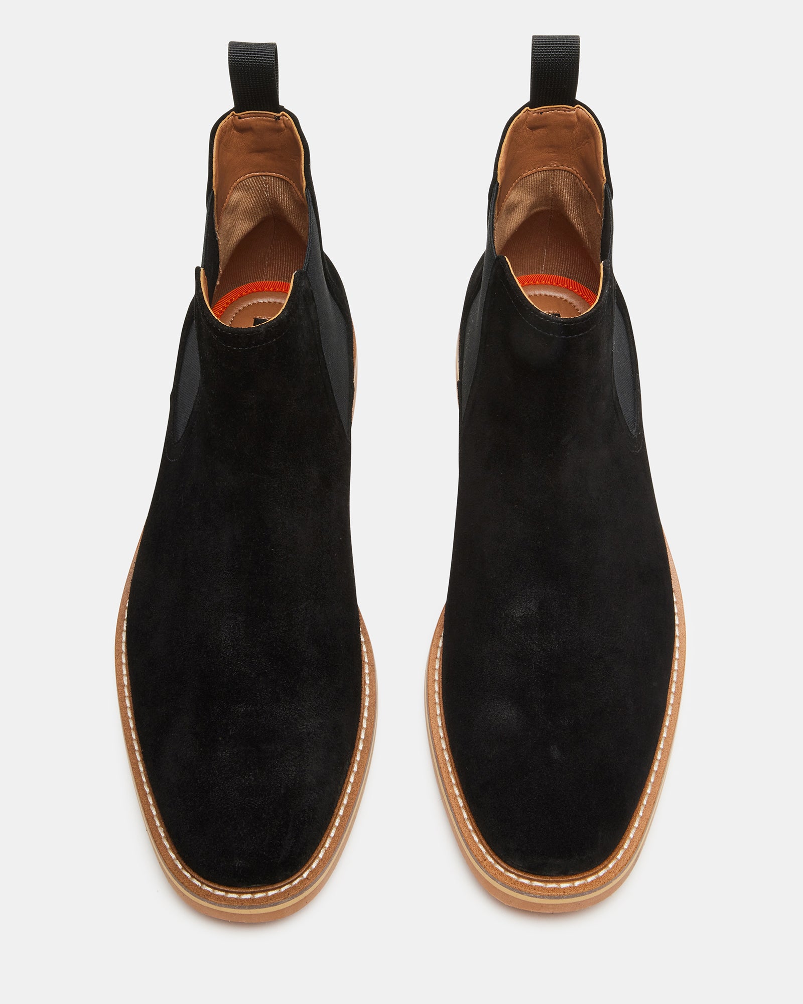 Top-down shot highlighting pull tab and ankle contour of suede boots