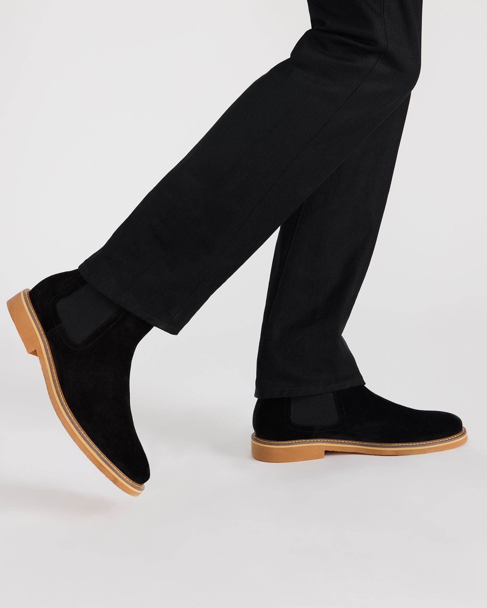 Top-down shot highlighting pull tab and ankle contour of suede boots
