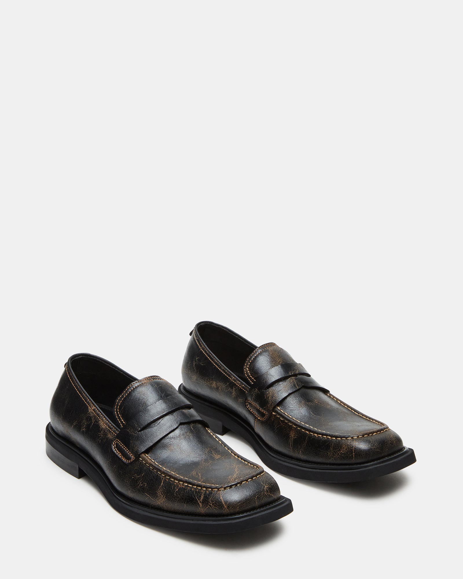 Close-up of Pericon distressed loafers, highlighting the luxurious leather material.