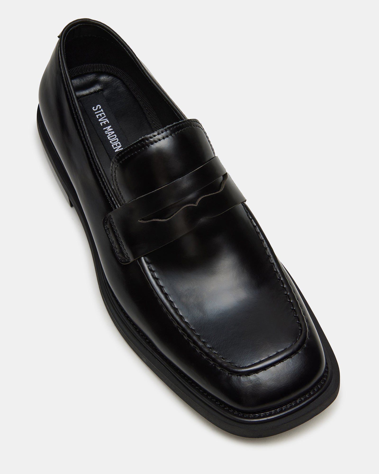 Stylish black patent leather shoes paired with tailored trousers