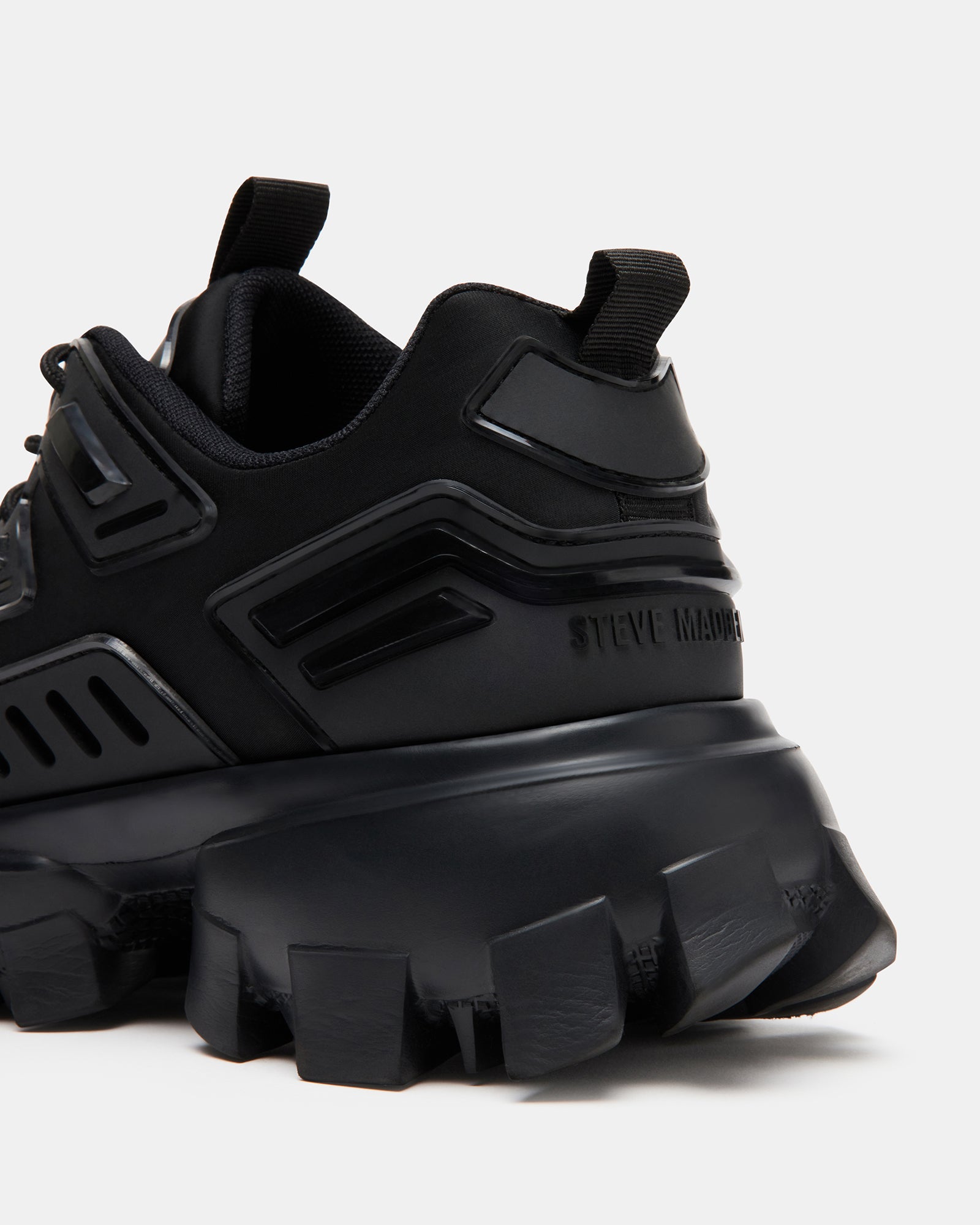 Close-up of textured upper and wide laced closure on black platform sneakers