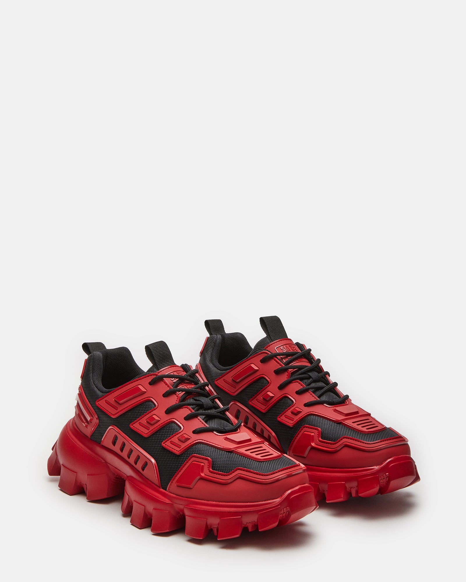 Angled view of red sneakers showing molded sole and textured upper details