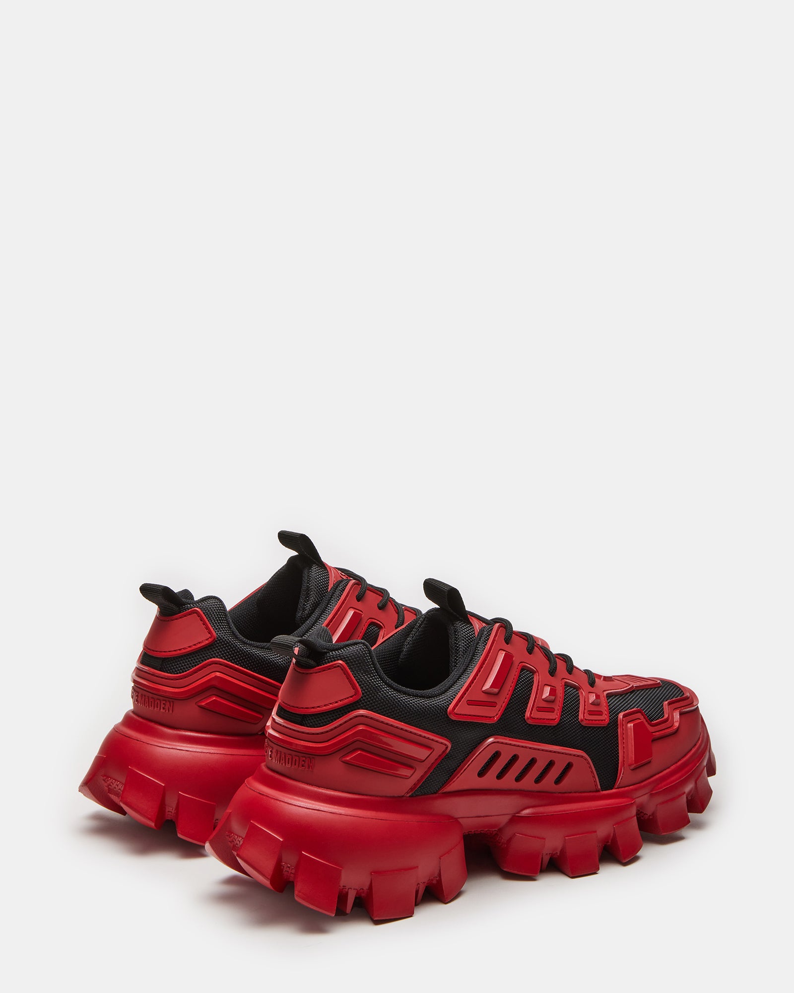 Angled view of red sneakers showing molded sole and textured upper details