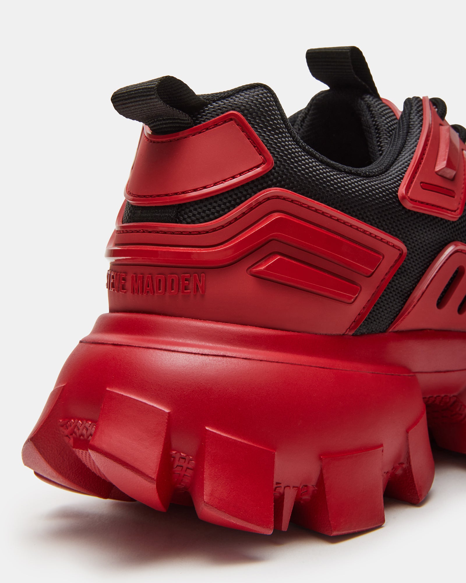 Overhead shot of red and black sneakers with wide laced closure, great for travel outfits