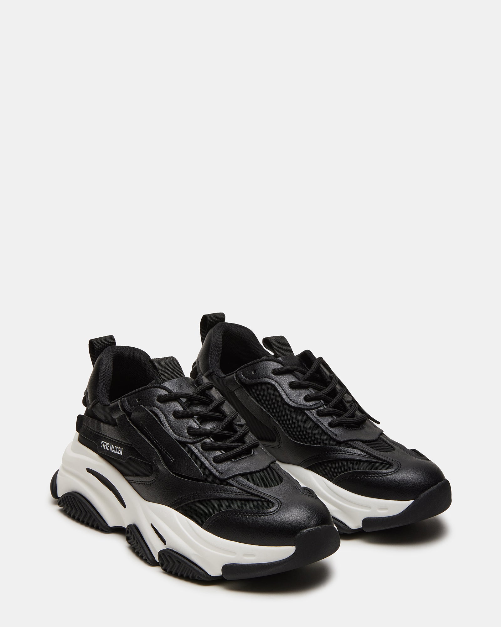 Close-up of vegan leather and mesh upper on black sneakers