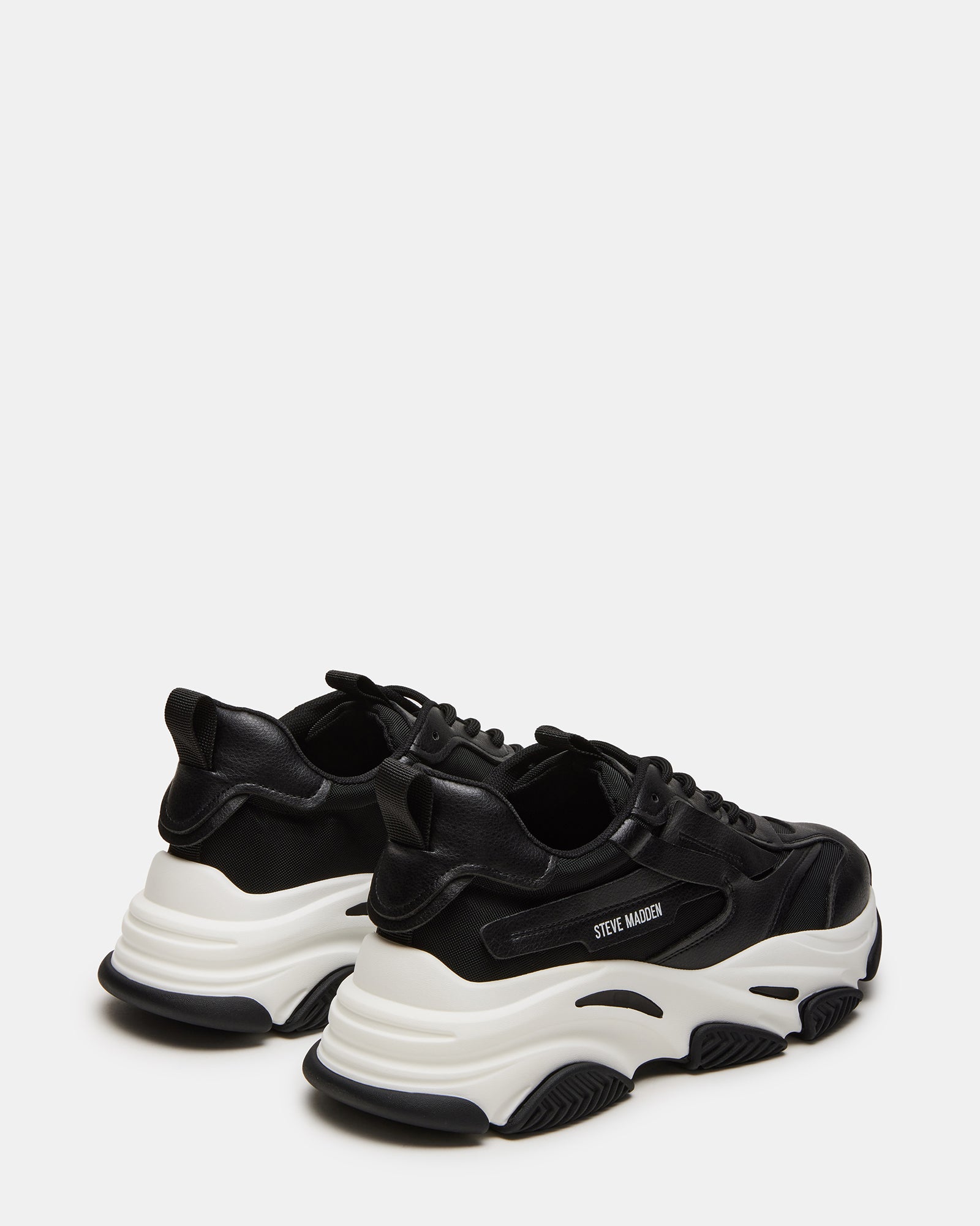 Close-up of vegan leather and mesh upper on black sneakers