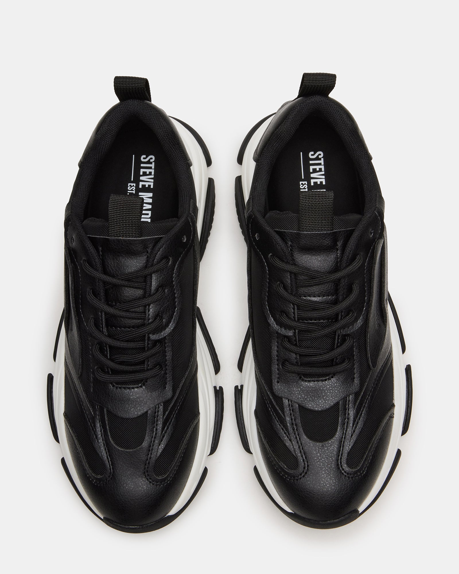 Black platform sneakers side view showing chunky sole and laced design