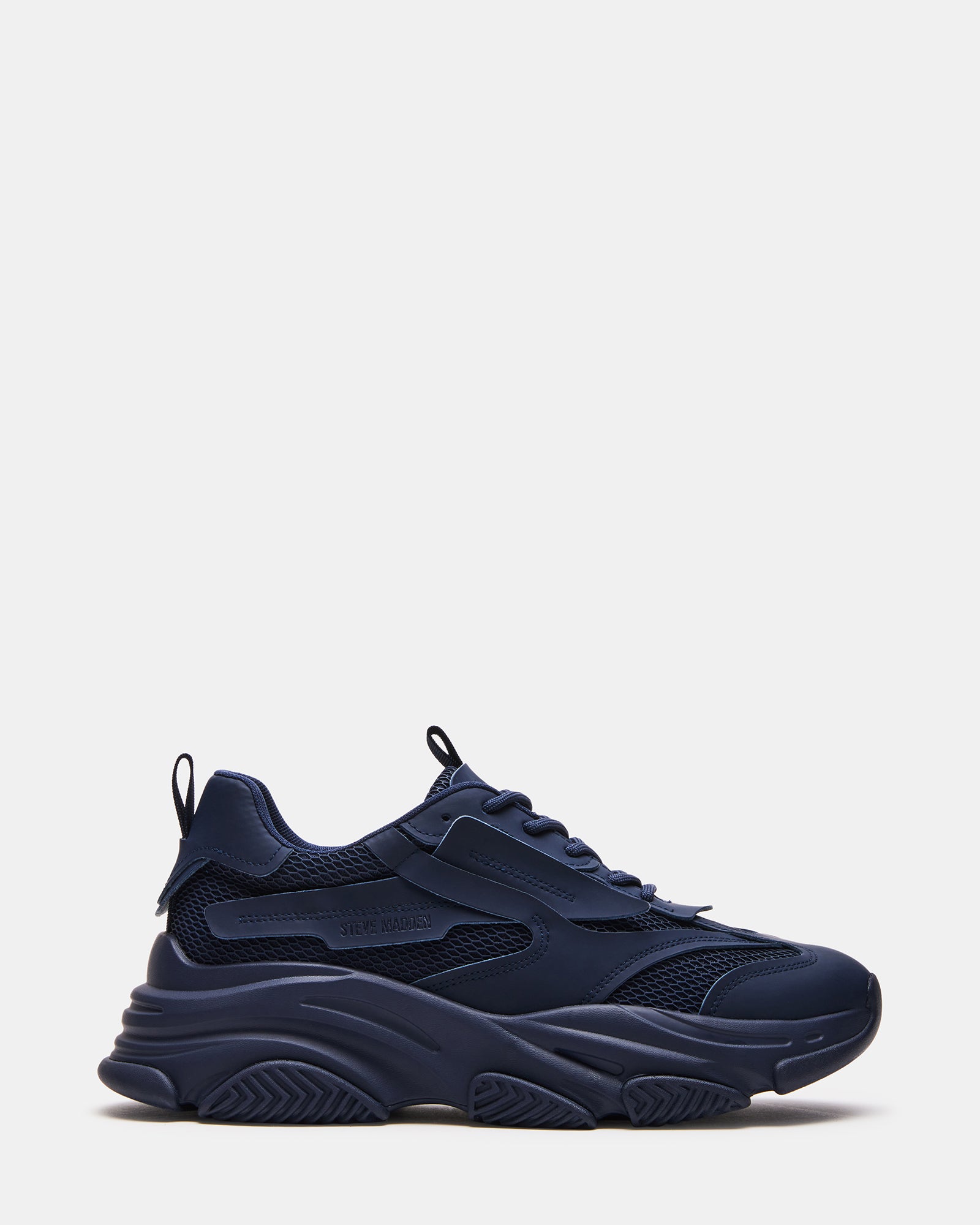 Side view of Possess Navy chunky platform sneakers on a street.