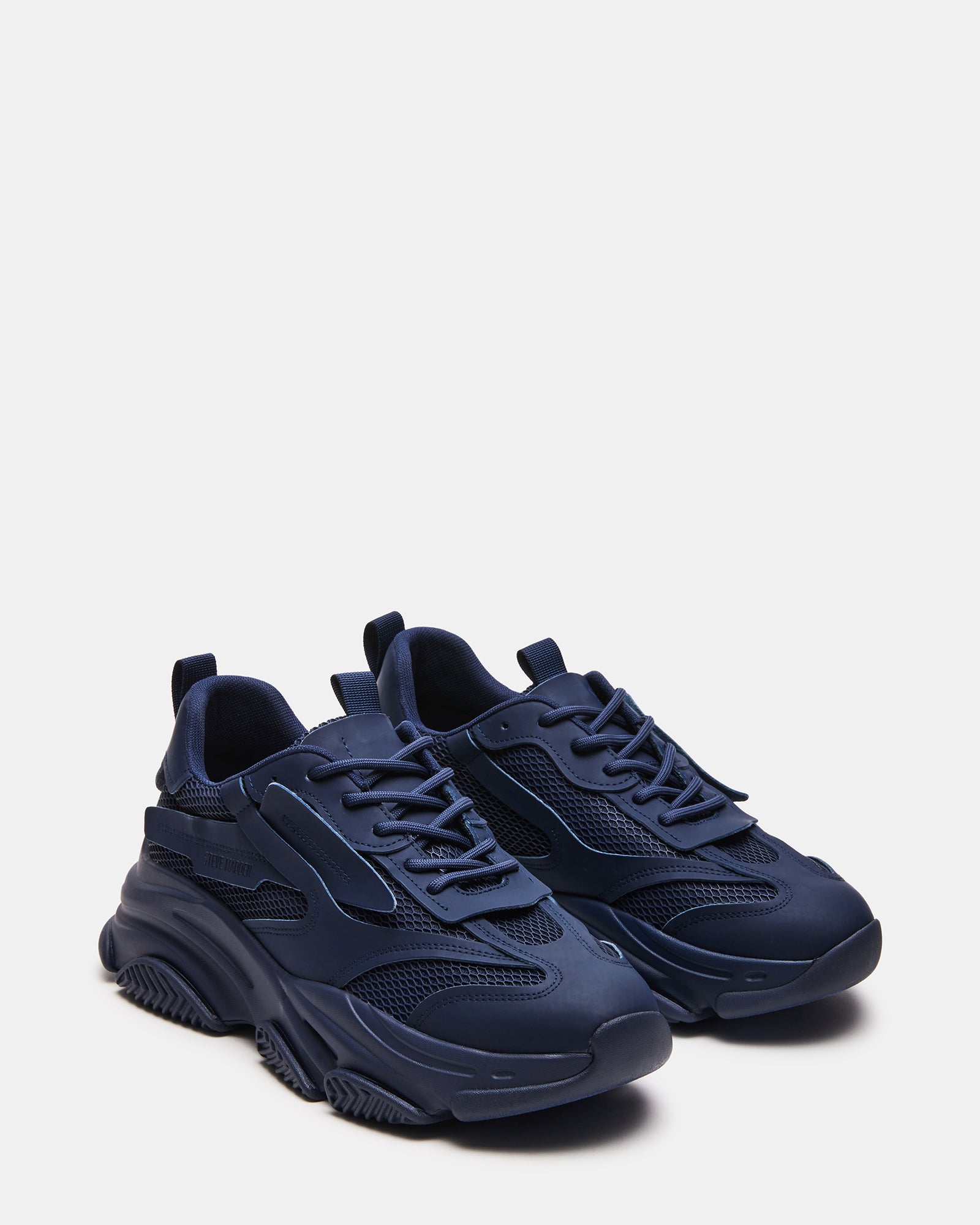 Close-up of the laced closure on Possess Navy sneakers.