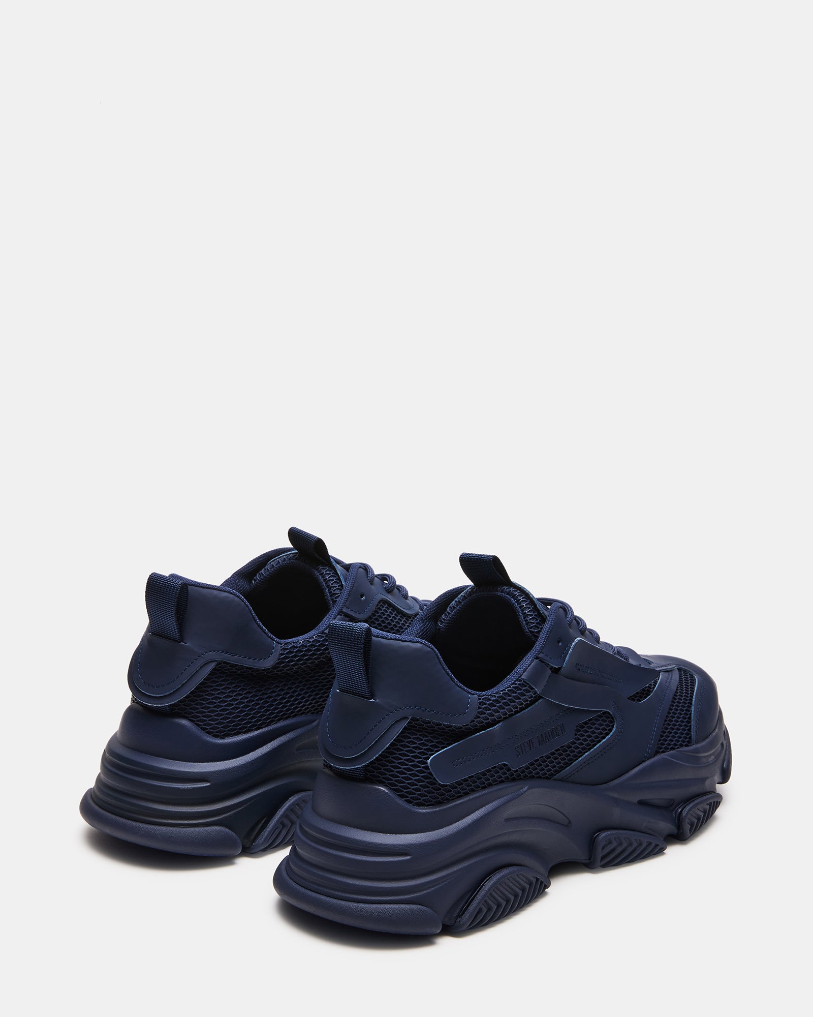 Close-up of the laced closure on Possess Navy sneakers.