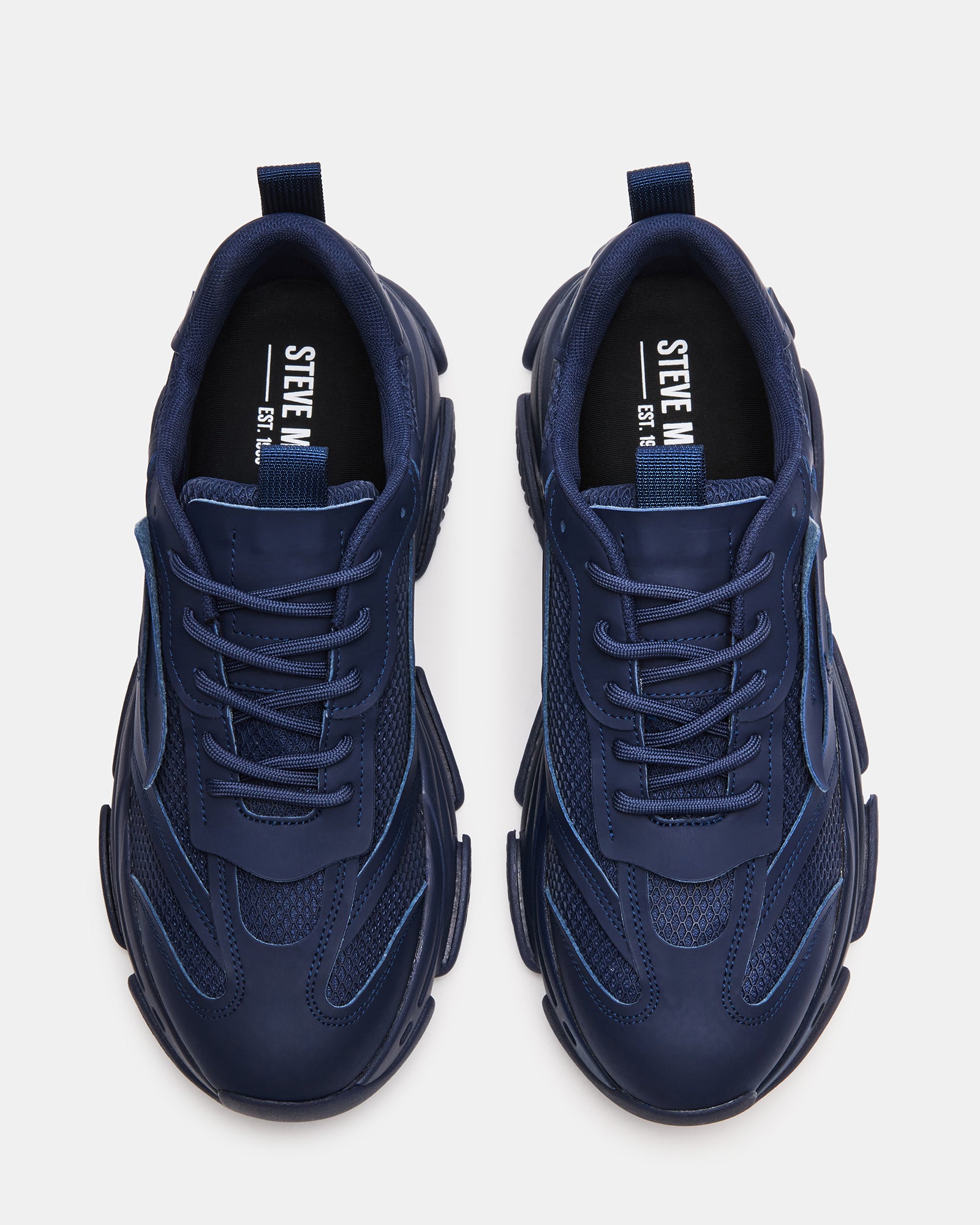 Side view of Possess Navy chunky platform sneakers on a street.