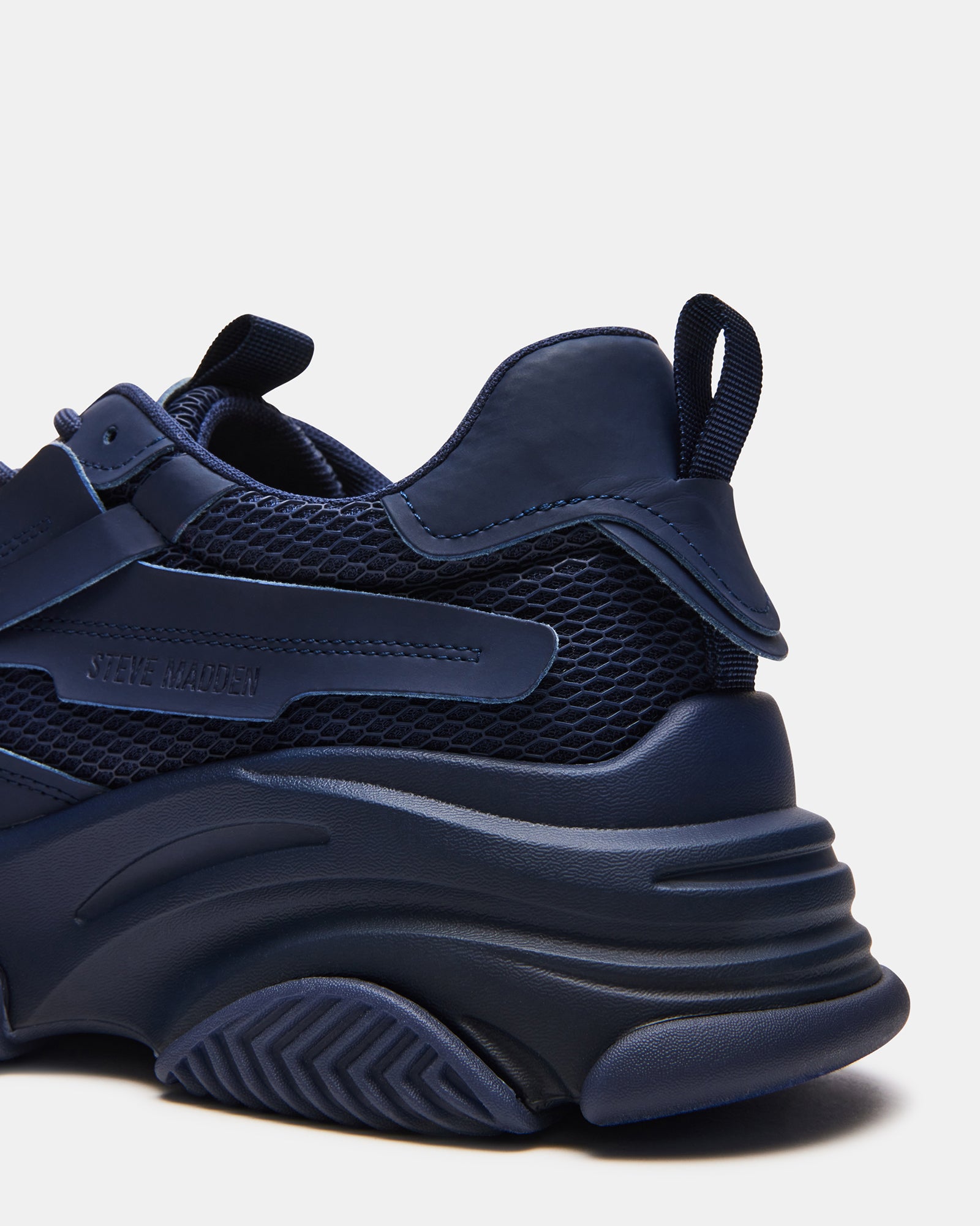Possess Navy chunky platform sneakers worn during a casual outing.