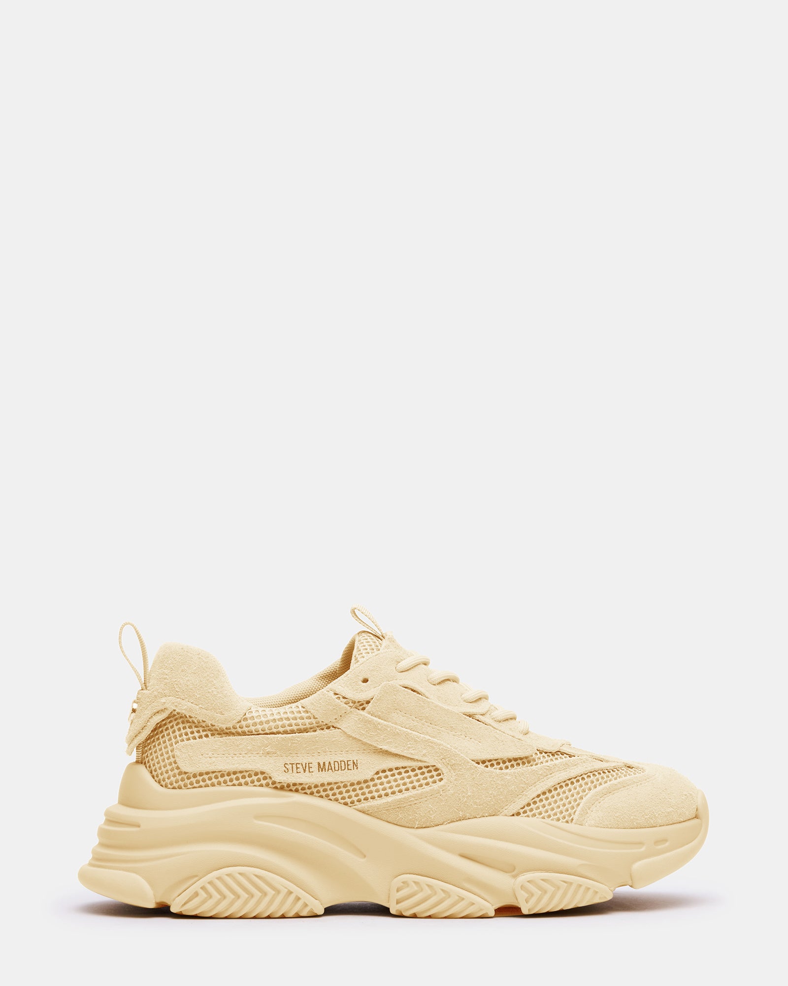 Side view of taupe chunky sneakers showcasing the molded sole and laced closure.