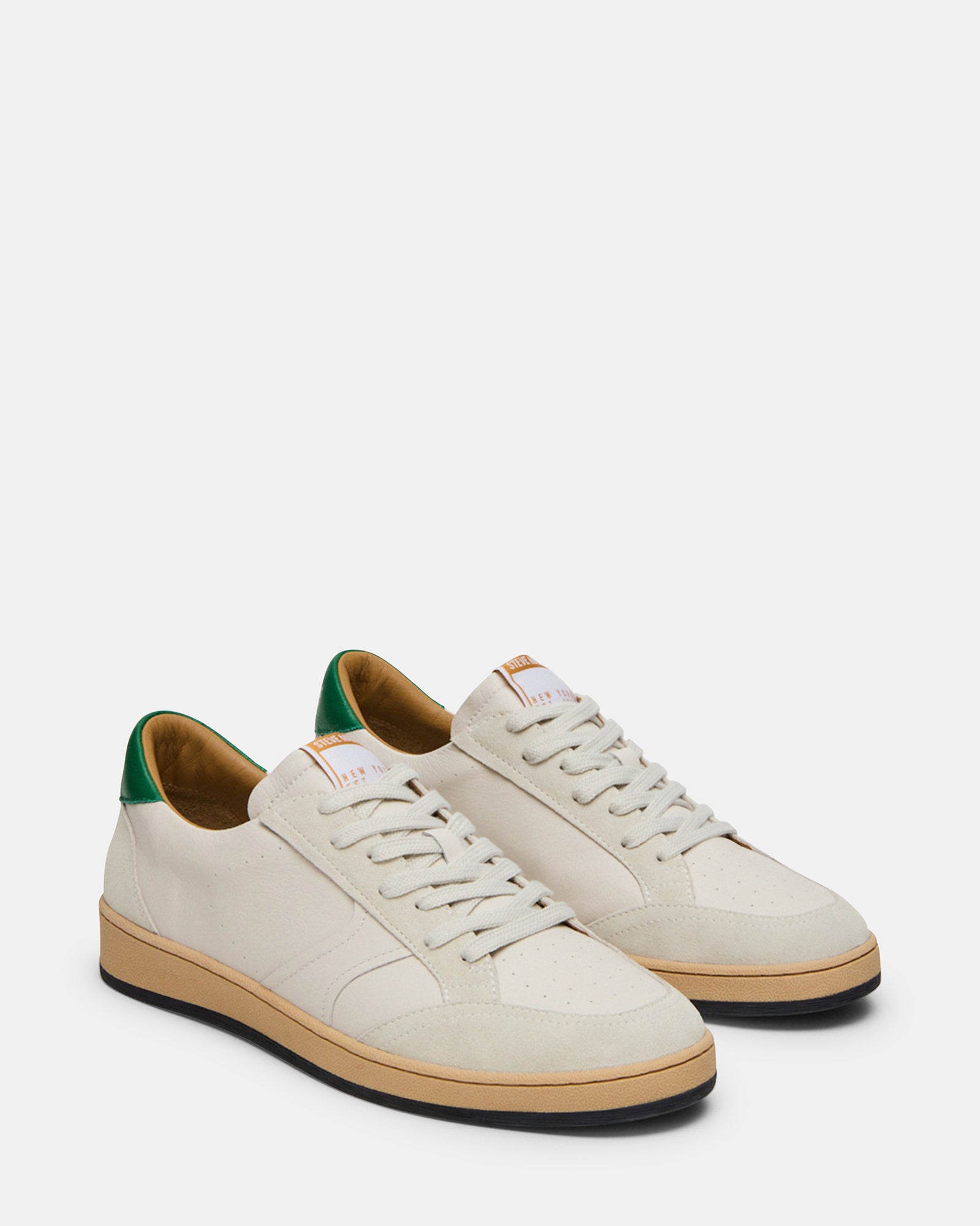 Back heel detail of brown leather sneakers highlighting stitching and material blend