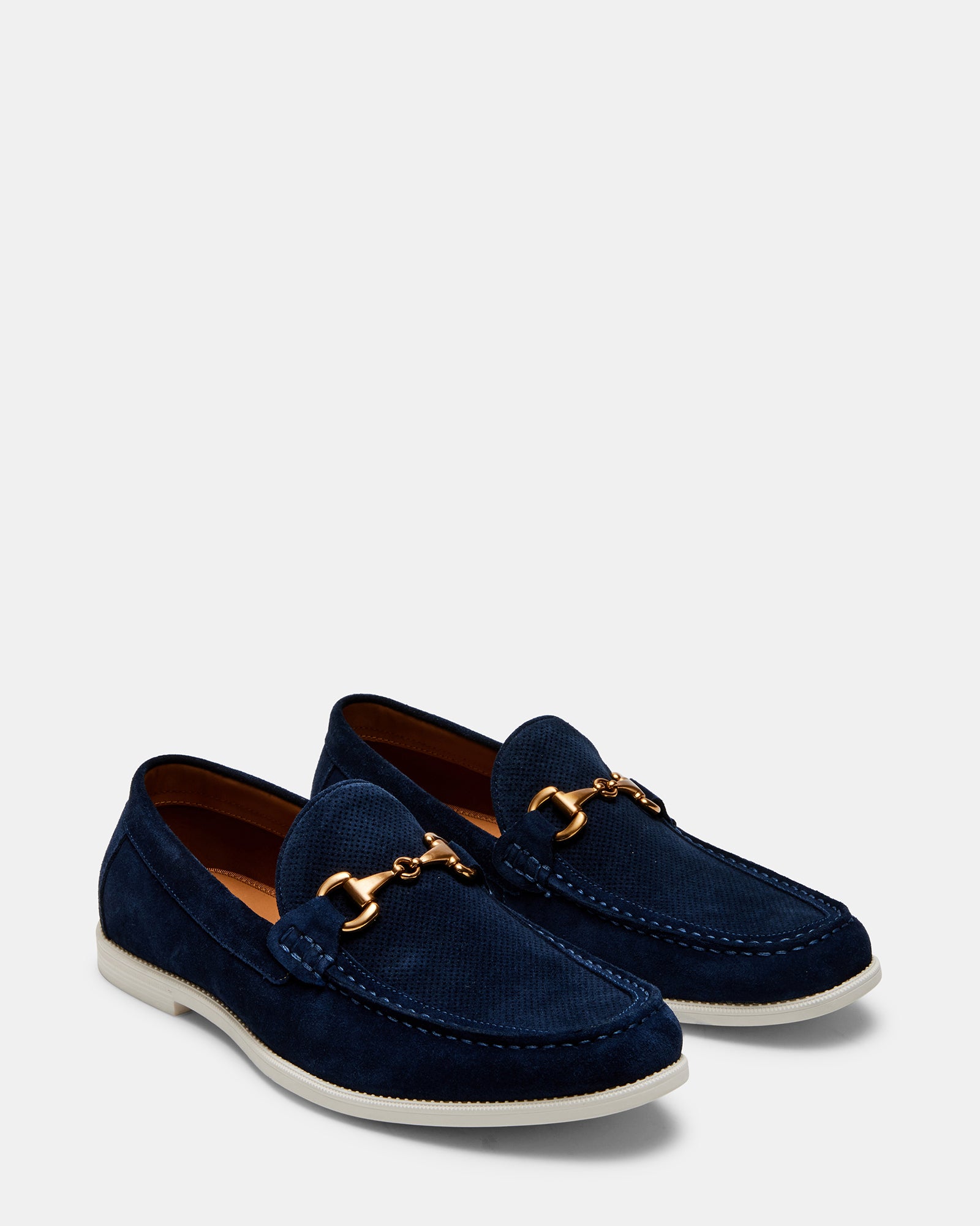 Close-up of suede shoes highlighting the vamp metal bit and rich texture