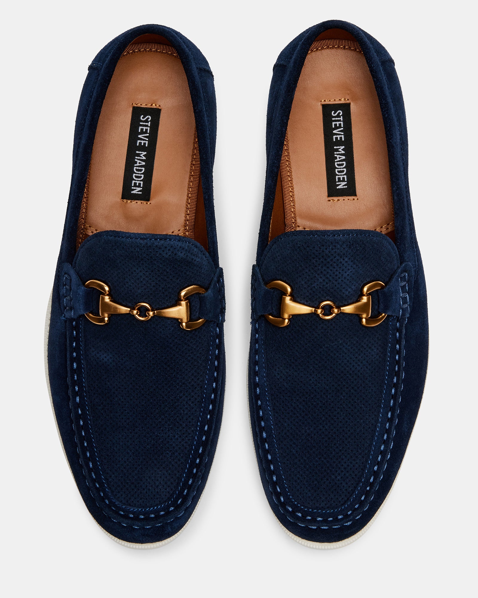 Side view of navy suede penny loafers showing moc toe and textured rubber sole
