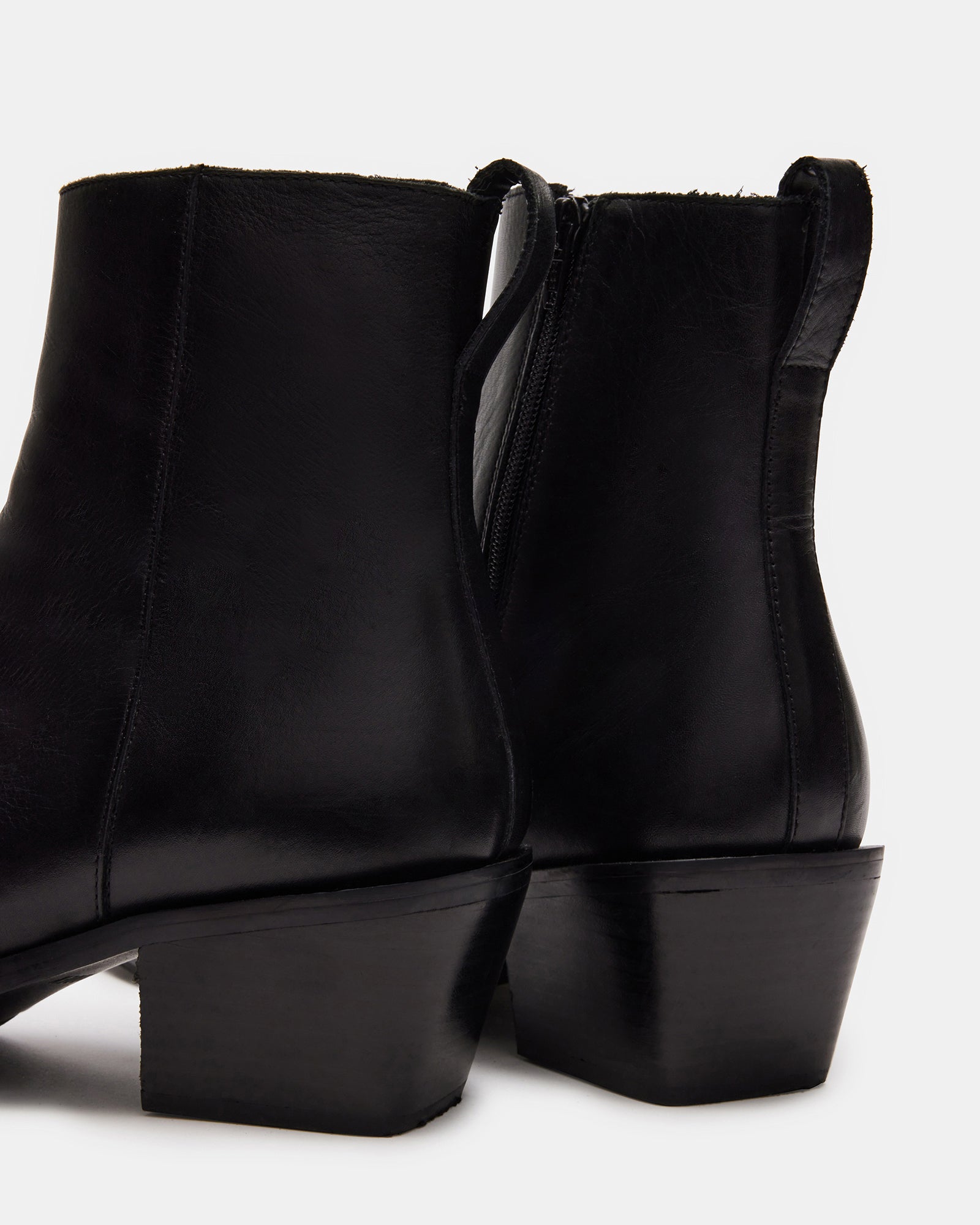 Top-down view of black leather ankle boots designed for modern wear.