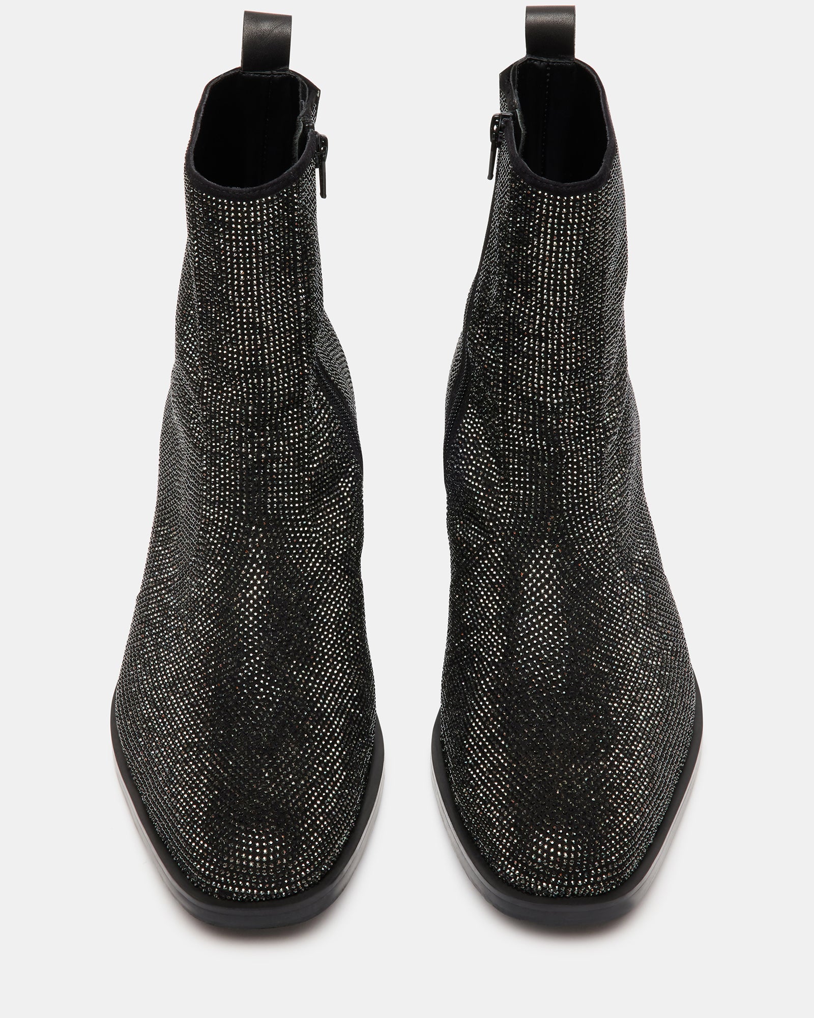 Side profile showing zipper closure on black womens ankle boots