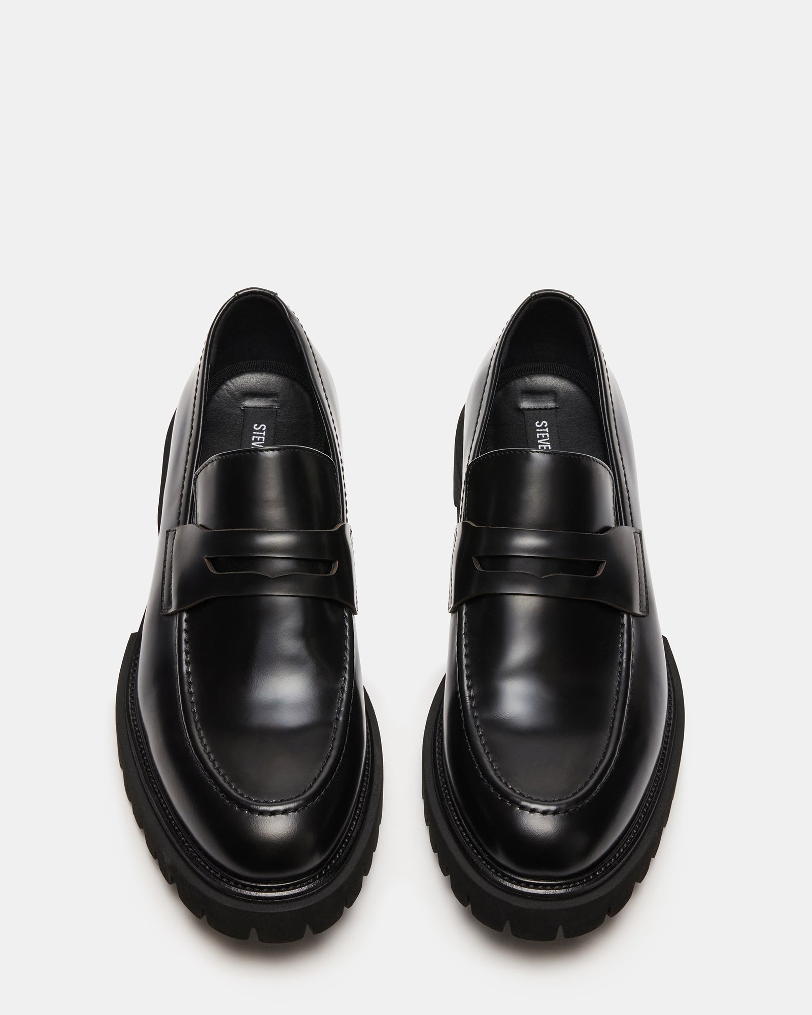 Black leather loafers side view showing stitching detail