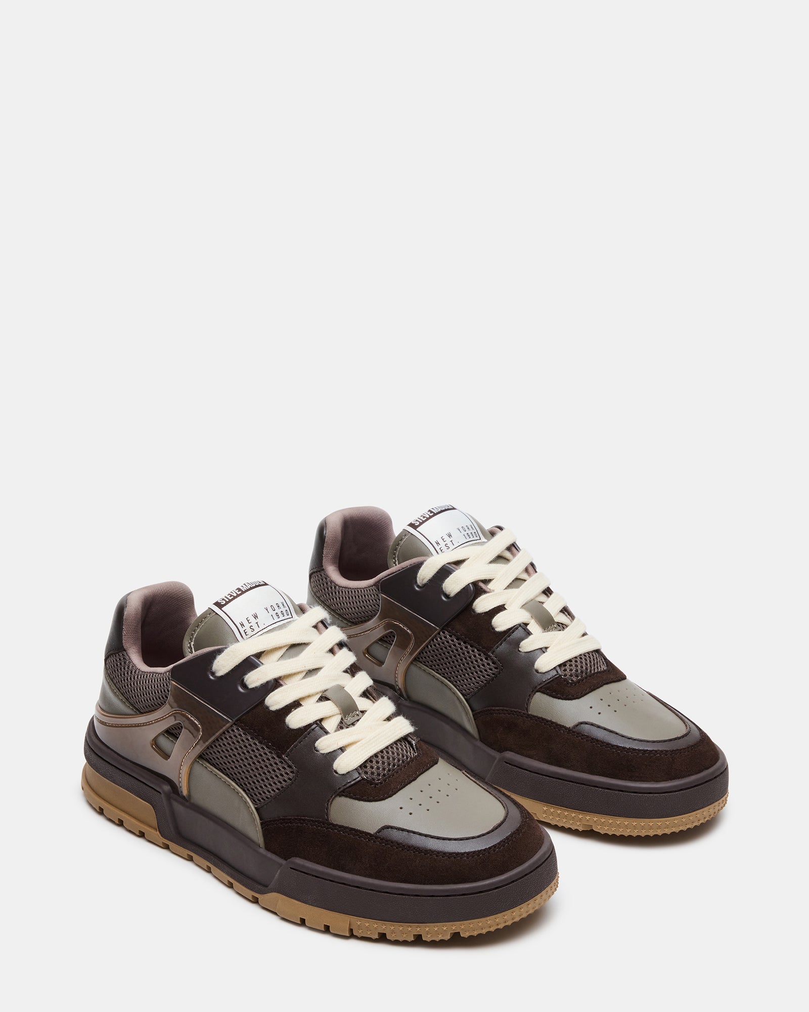Close-up of Sanchez multi-tone lace-up sneakers highlighting the suede material.