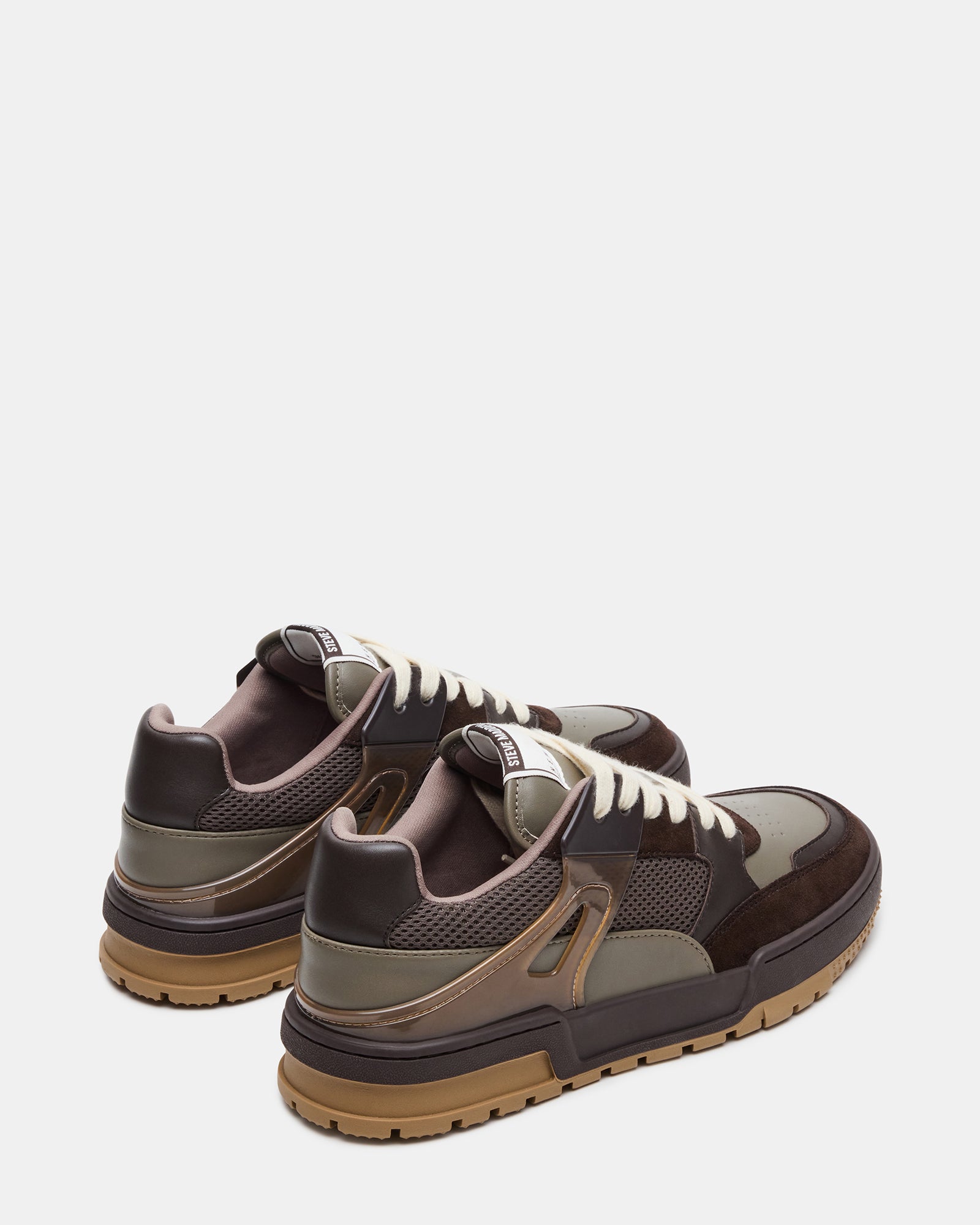 Close-up of Sanchez multi-tone lace-up sneakers highlighting the suede material.