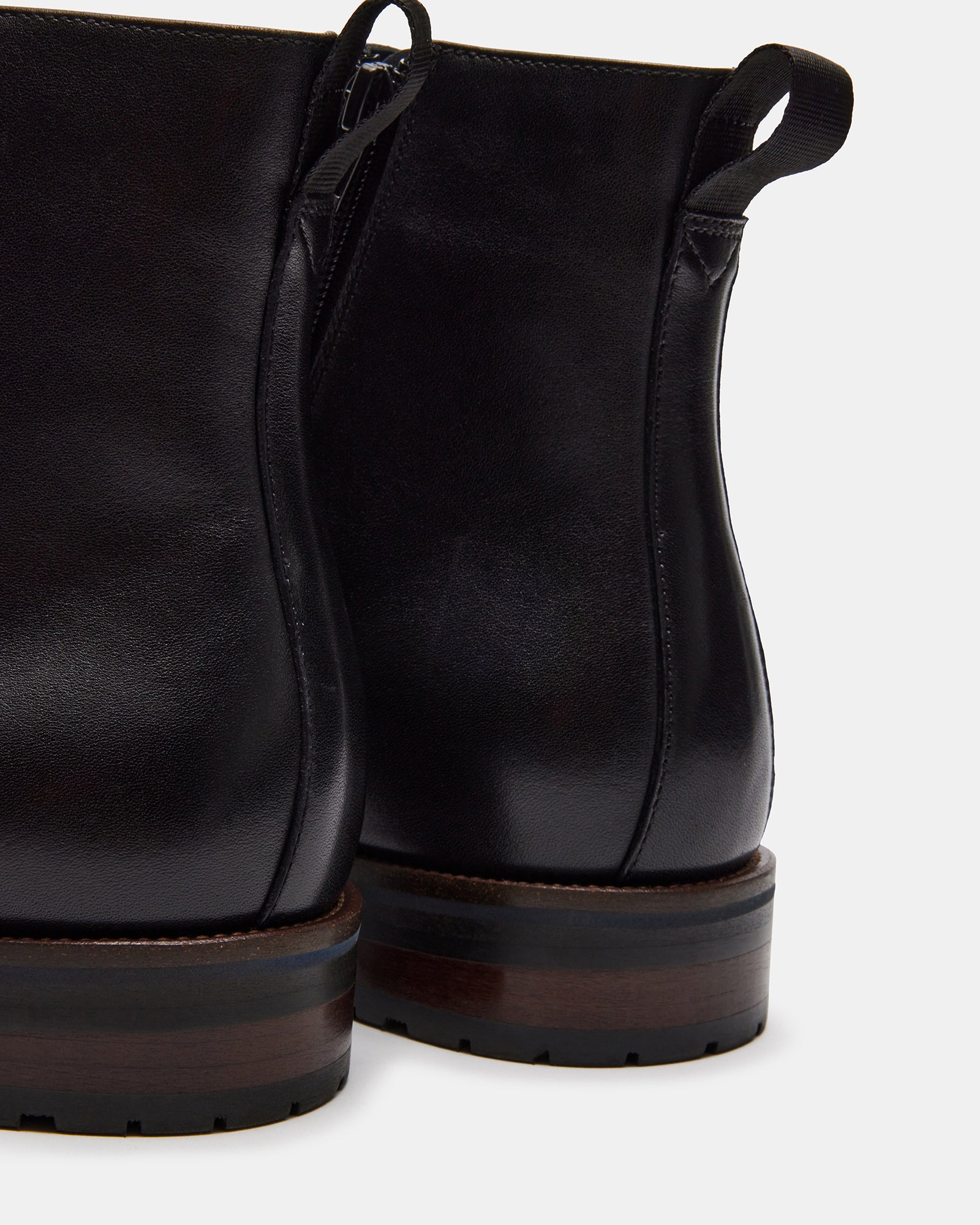 Sixtet black leather ankle boots worn with a casual outfit.
