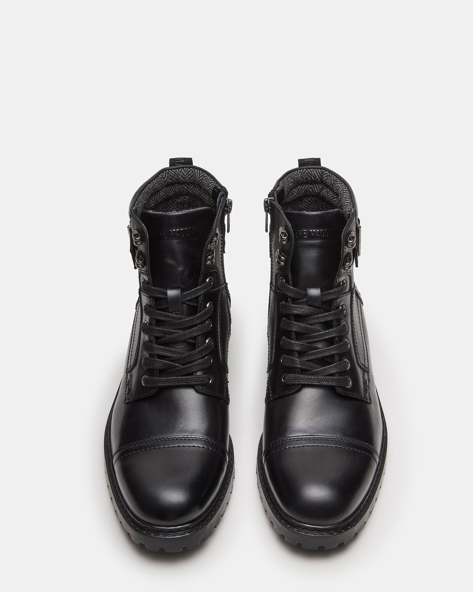 Side profile of black ankle boots with buckle and lace details, styled for fall fashion