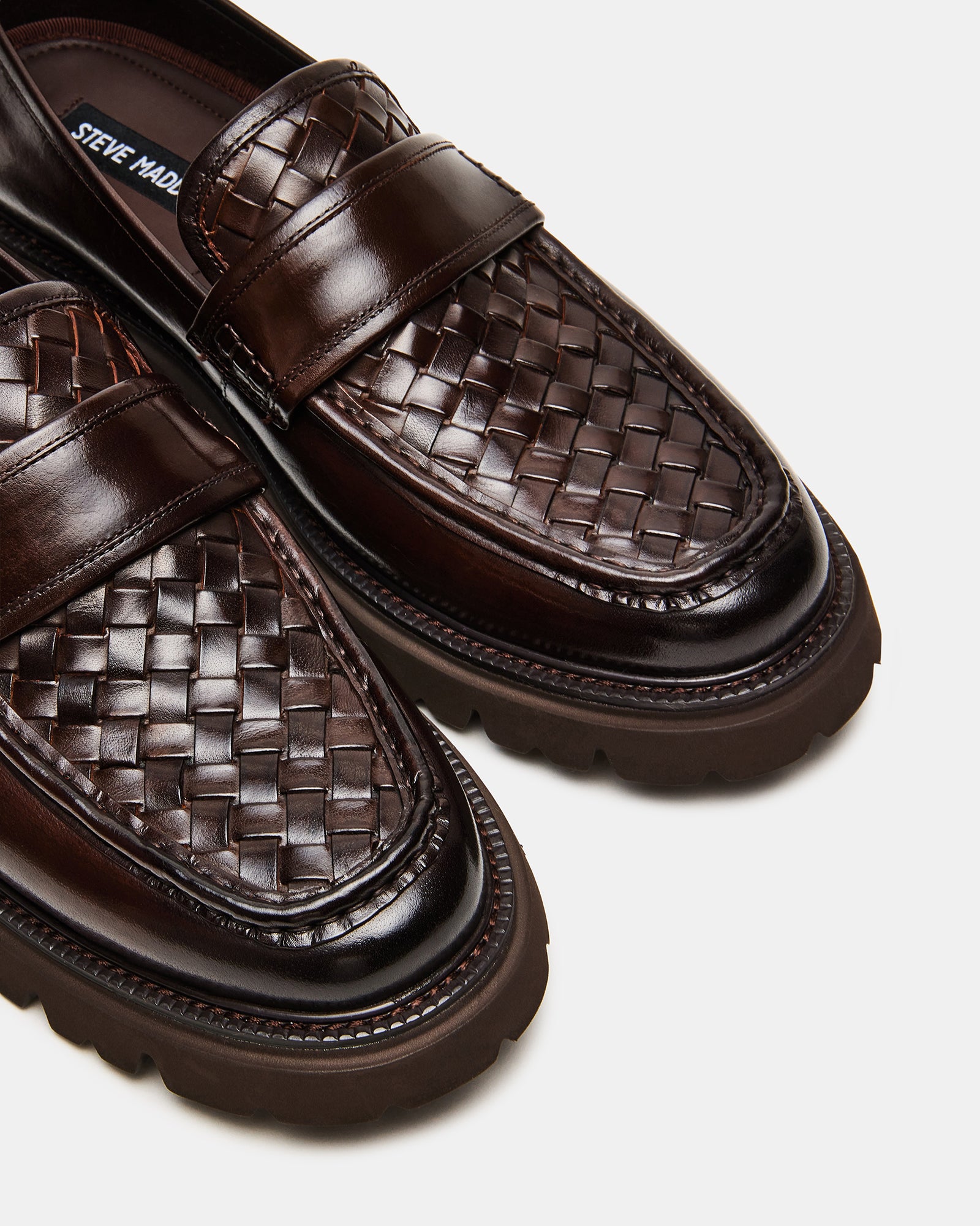 Brown leather loafers for women displayed on a stylish surface.