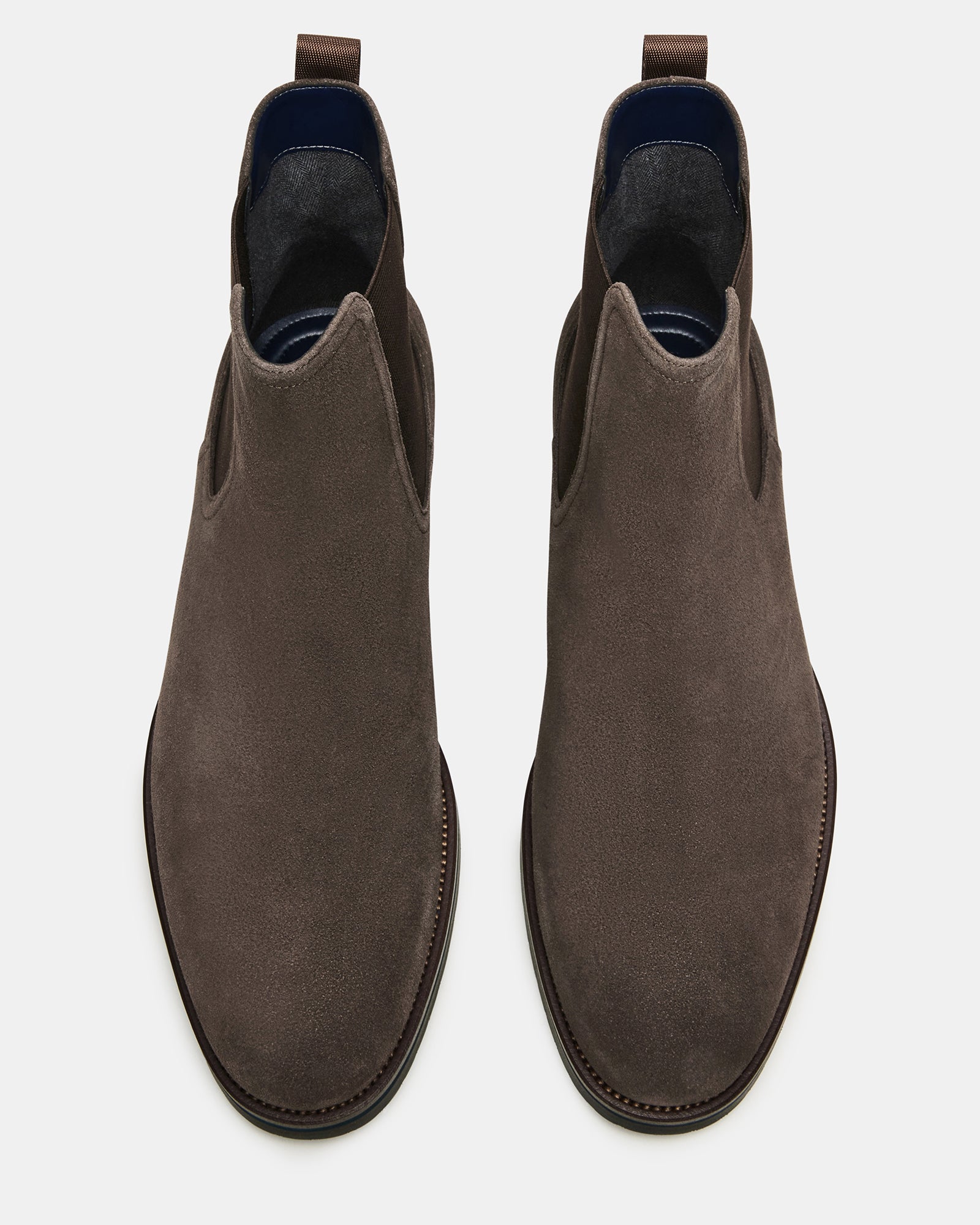 Side angle of brown suede ankle boots showing stretch inset and heel tab